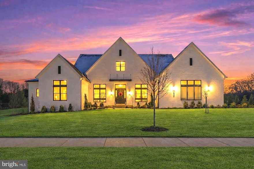 Immaculate custom Craftsman estate in the prestigious Arden community of Great Falls, newly built in 2023. This architectural masterpiece features 5 bedrooms and 7 bathrooms on 8,217 square feet on a private 0.87 acre lot. Thoughtfully designed open floor plan flows seamlessly from formal entertaining spaces to relaxed everyday living areas, balancing elegance with warmth, offering sought after main level living. The foyer opens to a sophisticated formal dining room and an office. Exceptional chef’s kitchen featuring professional grade stainless steel Wolf/SubZero appliances, six burner cooktop, double ovens, oversized center island with seating, custom cabinetry accented by designer hardware, expansive walk-in pantry, and a sunlit breakfast room overlooking serene woodland views. The living room is perfect for entertaining featuring a cozy gas fireplace. The main level embraces true indoor-outdoor living with expansive accordion glass doors that open completely from the living room to the patio. Main level owner’s suite with peaceful wooded views, dual custom walk-in closets, and a spa-inspired bath complete with a soaking tub, oversized glass-enclosed shower, and dual vanities with premium finishes. Two additional ensuite bedrooms on the main level provide exceptional flexibility for family or guests, while a private in-law suite offering its own sitting area and dedicated laundry, creates multi-generational living potential. Fully finished walk-out lower level transforms the home into a private retreat for recreation and entertainment, featuring a custom wet bar and lounge area, a state of the art home theater with projector, a dedicated gym with professional rubber flooring, and an integrated golf simulator. This level also includes a fifth bedroom with an ensuite bath, a versatile bonus den or office space. The home also features a separate walk-out patio on the lower level. Outdoors backs to mature trees, that offers rare privacy while remaining minutes from everyday conveniences. Three car side loading garage connects to a thoughtfully designed mudroom, ensuring practical daily living without compromising style. Close  proximity to Vienna, Tysons, Reston, and Washington, D.C., while preserving the peaceful charm and estate style atmosphere for which Great Falls is renowned. Residents enjoy access to scenic parks, equestrian trails, upscale dining, and premier shopping. Nearby Spring Hill, Cooper, and Langley pyramid.