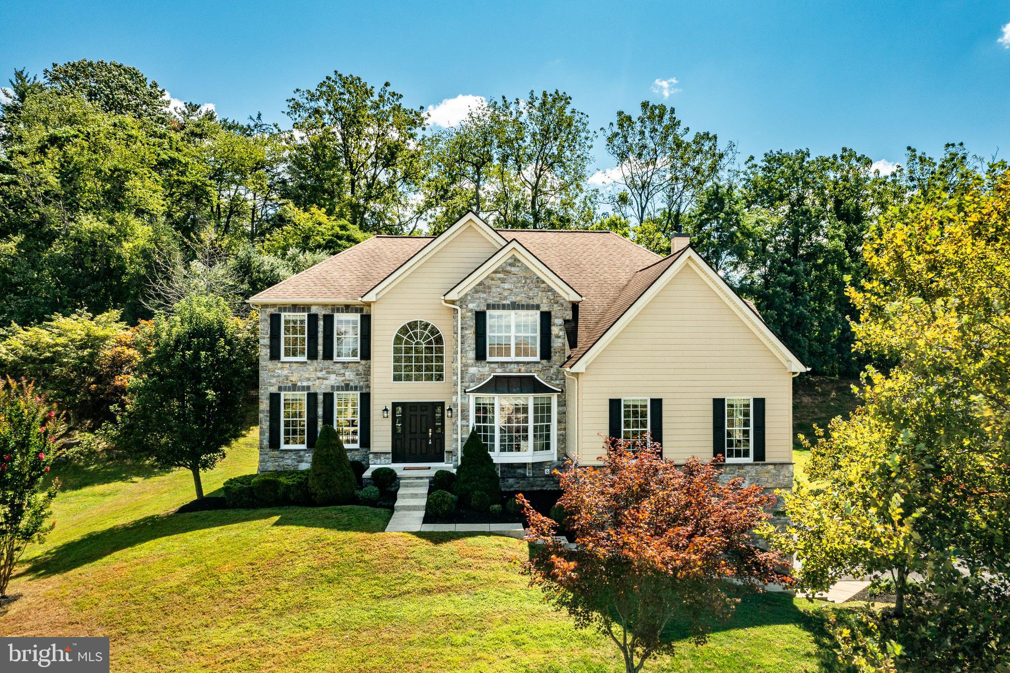 You found it! Tall Trees At Thornbury! Tucked away in Glen Mills but in the West Chester Schools. This amazing Toll Brothers home is ready for the next owner.
Step inside this impressive home with its two-story foyer, featuring real hardwood floors, elegant crown molding, a large arched window that fills the entry with natural light. To the left you will find a front to back living room and dining room combo that is perfect for large holiday meals and gatherings. To the right you will find a first floor study for work from home or evening work space. Because this home has the tuck under. 3 car garage, you get an enormous second family room or even a giant play space or hobby space. This flex space can be used in so many ways. The main family room has a floor to ceiling stone fireplace and wall of windows that overlook the deck and drench the space with light. The kitchen is in the heart of the home and a breakfast room and eat in space. Granite counters, lots of cabinetry, double ovens, deep sink and pantry are features of the kitchen many dream of. The laundry room in the back completes the first floor. Upstairs the main bedroom features a massive bath, oversized walk in closet and sitting room. 3 generous bedrooms and 2 full baths that lead back around to the 2nd staircase. This is a home that says, "I have arrived!" The best part is the location in Glen Mills. The home is convenient to the airport, tax free shopping in Delaware and very close to Rustin High. Being in the West Chester School District allows you to buy a luxury home with low taxes. This is the best of all worlds in location, condition, price and taxes. Come call 32 L'Enfant your home today.