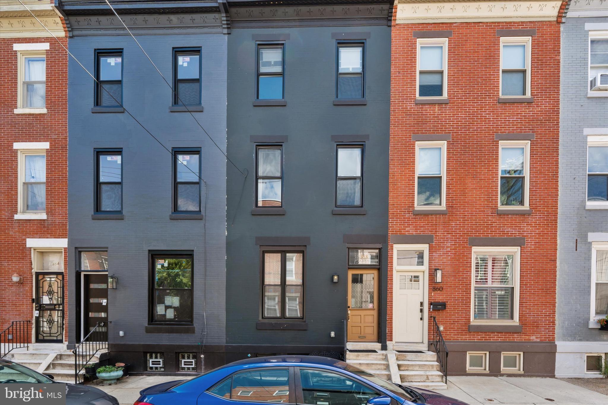 Welcome to this exquisitely crafted, luxury townhome nestled on one of Francisville’s most charming and well-maintained blocks. Blending timeless character with contemporary flair, this residence offers the best of Philadelphia city living—just blocks from The Met, Broad Street, the Philadelphia Museum of Art, and the Schuylkill River Trail. Step through the enclosed glass vestibule into an open-concept main level, where stunning hardwood floors, exposed brick walls, and black window casings set the tone for sophisticated urban living. The spacious living room features a reclaimed wood mantle that adds warmth and texture, seamlessly flowing into a stylish dining room with elegant decorative molding. The gourmet kitchen is a true showstopper—designed for both everyday elegance and culinary excellence. Outfitted with top-of-the-line appliances, shaker cabinetry, gold hardware, black granite countertops, a farmhouse sink, and custom reclaimed wood accents, the space is anchored by a breathtaking archway that frames a bespoke ILVE range and handcrafted range hood, set against an artfully designed tile backsplash. A powder room with a floating sink and a laundry/mudroom with chic checkered tile flooring complete the first floor. Up the beautifully refinished original staircase, the second level features three spacious bedrooms and a spa-inspired full bathroom. One bedroom includes a sealed fireplace—a charming nod to the home’s historic roots—while another showcases exposed brick for added character. The bathroom boasts a floating double vanity with marble countertops, custom tile flooring, and a tub/shower combo. The third floor is an unforgettable primary suite retreat. With a tastefully paneled accent wall, exposed brick detail, and a thoughtfully integrated vanity nook, this space combines comfort with elevated design. A dressing area leads to a truly luxurious bathroom featuring a massive walk-in shower with dual shower heads, a custom double vanity, and a sculptural freestanding soaking tub—your personal spa escape. The fully finished basement offers even more versatile living space—ideal for a home office, gym, or media room—while the fenced-in concrete patio is perfect for outdoor entertaining or private relaxation. Don’t miss this rare opportunity to own a one-of-a-kind home where every detail has been carefully curated for style, function, and comfort—right in the heart of one of Philadelphia’s most vibrant neighborhoods. Schedule your private tour today and fall in love with this beautiful home!