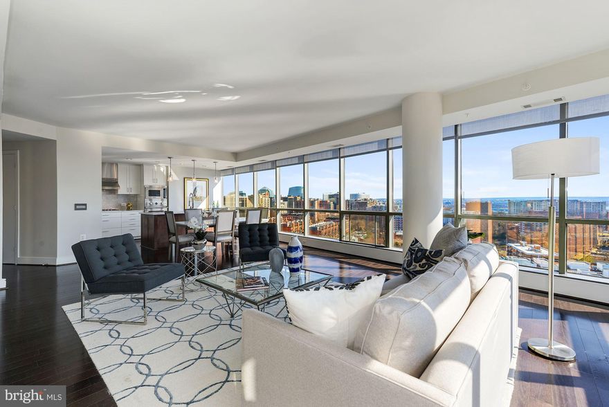 Penthouse style living in The Odyssey, one of Arlington's premier condo buildings. Stunning 180-degree views of DC skyline plus new finishes, custom cabinetry, Calacatta Statuaryo marble counters, Grohe faucets, & top-of-the-line appliances. Features 2 balconies, 2 garage parking spaces, & 2 storage units. Full-service building with fitness center, rooftop pool, & concierge. 2 blocks to Metro!