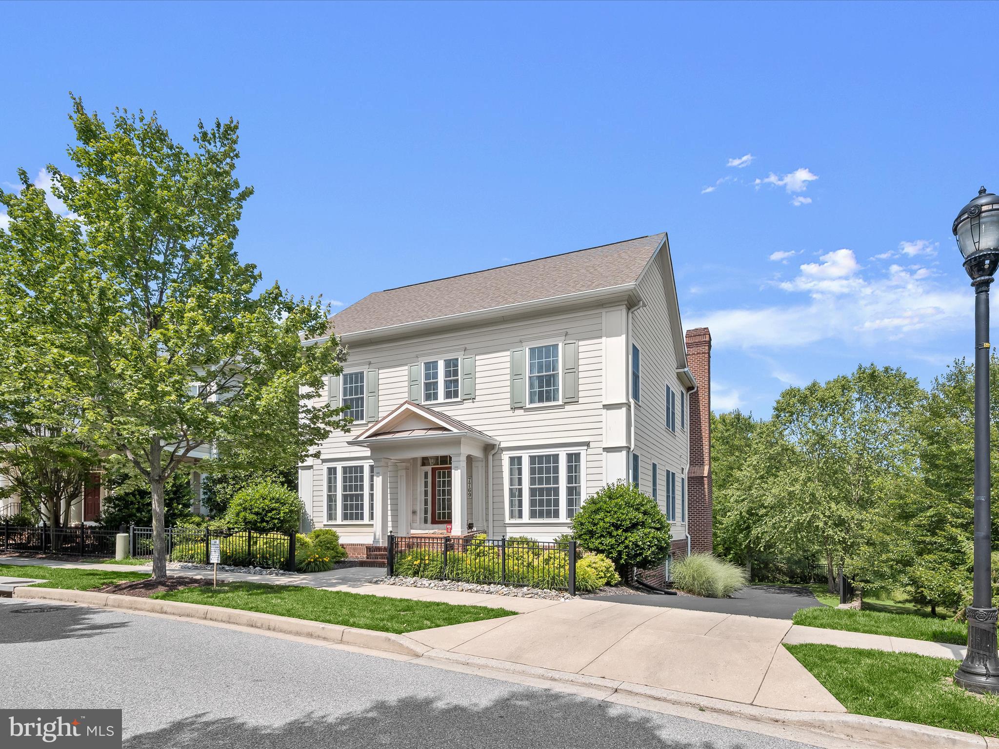 Welcome home to 7769 Water Street in Maple Lawn - a rarely available single family home sited on one of the premiere perimeter lots in this highly sought after community. One of the crown jewels of the Hillside District, this meticulously maintained home is completely surrounded by a picturesque, private wooded backdrop. The beautiful view of the conservation area is enjoyed through nearly every single window. Built by luxury home builder Mitchell & Best, this stately home features the Hamilton III floorpan and offers a private rear driveway not shared by other neighbors. The sophisticated main level offers 10' ceilings and hardwood flooring throughout. It features a formal living room adorned with three-piece crown molding, a formal dining room with crown molding and chair rail, and a spacious office with oversized windows. The living room offers a cozy wood-burning fireplace, a coffered ceiling, and a wall of windows providing a serene view of the conservation area. The gourmet kitchen showcases two-tone cabinetry, a large center island with granite countertops and top-of-the-line Kitchen Aid stainless steel appliances. The TREX Deck is accessible from both the sunroom and living room. Additional main level amenities include a butler pantry and a convenient half-bath.
The upper level presents exceptional living space with a primary bedroom featuring a tray ceiling, a spacious sitting room, and two walk-in closets. The en suite primary bathroom boasts two vanities, a soaking tub, and a shower stall. A guest room with its own en suite bathroom provides additional privacy, while a secondary bedroom includes multiple windows with amazing views. The hall bathroom is equipped with a dual sink vanity. A reading nook and a convenient laundry room complete the upper level. The lower level offers an expansive recreation room, a guest bedroom, and a full bathroom providing ample space for entertaining and accommodating guests. It includes a coat closet and a storage area for added convenience. This level offers easy access to the 2-car garage and is well-lit with strategically placed recess lights throughout. Conveniently located close to all major Baltimore/DC commuter routes, and with enviable amenities including a resort-style community pool, tennis courts, pickleball courts, basketball courts, state-of-the-art gym and more, you’ll quickly see why Maple Lawn is an award winning planned community unlike any other in Howard County.