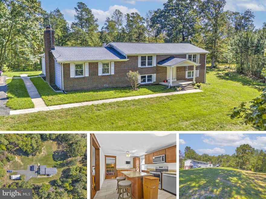 Welcome to this extraordinary 29.5-acre wooded estate offering the perfect blend of craftsmanship, updates, and endless possibilities. Step inside the 2,700+ sq ft home and immediately admire the fine details, including the striking cedar beam accent and dual stairways that set the tone for its timeless character.  At the heart of the home, the expansive kitchen impresses with sleek tile flooring, granite countertops, stainless steel appliances, and abundant cabinetry and counter space—a true chef’s dream. You’ll find an exquisitely updated guest bath, generously sized bedrooms, and a large owner’s suite complete with a walk-in closet and a spa-like en-suite showcasing floor-to-ceiling tile and a walk-in shower.  The main level offers plenty of room to gather, with a large dining room, spacious family room, and a one-of-a-kind all-season room. The finished basement adds even more versatility with a cozy wood stove, three additional bedrooms, and a fully updated bathroom.  Outdoors, enjoy two open field areas ideal for recreation, gardening, or even horses. A detached enclosed workshop with a separate 200-amp service provides the perfect space for hobbies or extra storage. Wildlife watching, gardening, or simply relaxing—this property invites you to live your dream lifestyle.  Practical updates include a newer roof, A/C, furnace, well pump, and hot water heater for peace of mind. All of this just minutes from shopping, dining, Pax River, and more!