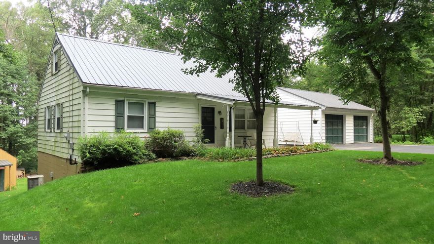Charming 4 bedroom, one and half bath cape cod on private half acre with 2-car garage and beautiful landscaping and koi ponds! Updated kitchen with all newer stainless steel appliances, tons of cabinet and counter space, pantry cupboard and dining area with newer vinyl plank flooring.  Living room with laminate flooring, maintenance free full bath and 2 bedrooms on first floor, both with closets! Second floor has 2 additional bedrooms, each with closets and a convenient half bath. Lower level has laundry facilities, a den and a work room and has walk out access to rear deck and yard. Forced hot air and central air conditioning. Refinished deck for entertaining between the house and large 2-car detached garage! Rear yard is surrounded by trees, has small shed/outbuilding and also contains a private paradise of landscaping, custom decking and koi ponds.  Beautiful, rural setting but not far from shopping, restaurants and town.