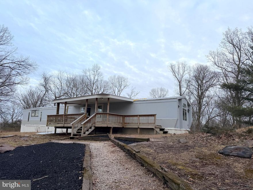 Situated on 1.33 acres, this well-maintained mobile home offers space, functionality, and great outdoor features. The home includes a living room, kitchen, 3 bedrooms, and 1.5 baths, providing a comfortable layout for everyday living. Enjoy the outdoors from the large covered deck, perfect for relaxing or entertaining. The property also features a spacious pole barn 28 x 32, ideal for storage, hobbies, or a workshop, along with off-street parking for added convenience. There is an underground basement in the rear of the home.  A great opportunity for country lovers and those seeking peaceful surroundings with practical amenities! Property appraised in 2025 for $216,000