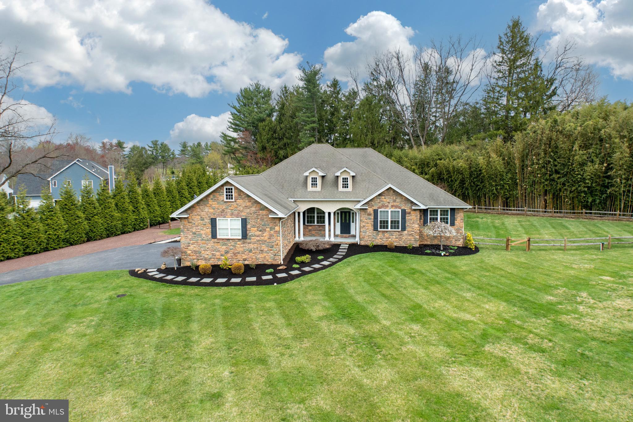 Welcome to this elegant ranch-style home, nestled on a beautifully landscaped private, flat acre+ lot in one of East Goshen’s most desirable locations. This exceptional residence blends timeless charm with modern luxury, offering a bright, open floor plan ideal for both relaxed living and stylish entertaining.
Step through the front door and you’re immediately welcomed by gleaming hardwood floors, detailed moldings, and a sunlit, inviting interior. At the heart of the home is a gourmet kitchen, thoughtfully designed for everyday living and entertaining alike. It seamlessly opens to a spacious great room, anchored by a gas fireplace and French doors that lead to a tranquil outdoor patio, ideal for indoor-outdoor gatherings.
A formal dining room, is gracefully set off of the great room, adds a touch of sophistication and opens to the entry foyer. The luxurious first-floor spacious primary suite offers a private sitting area, French doors to the patio, and ensuite bath featuring a large walk-in shower, Jacuzzi tub, and a dual vanity.
Two additional, generously sized bedrooms share a full hall bath. The laundry room is conveniently located on the first floor enhancing everyday functionality. In addition to a well designed first floor - the custom-finished basement adds incredible versatility and space - delivering the fourth bedroom with a full bathroom, bar area, home gym, and additional recreation space—perfect for additional living space, entertaining, or a private in-law suite. This rare offering on a peaceful setting is completed by an oversized 3-car garage, fenced in backyard and is conveniently located to Paoli Pike, Route 202, Downtown West Chester and East Goshen Park! Showings will begin on Friday 4/11.