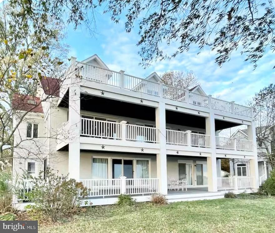 This custom-built home offers approximately 4,400 square feet of living space and unparalleled views of Chesapeake Bay from nearly every room. Designed for both comfort and entertainment, the home features a 1,000 square foot great room with vaulted ceilings and red oak floors. The spacious, open layout includes a chef’s kitchen with granite countertops, stainless steel appliances, and three dining islands, all seamlessly connecting to the dining area and family room, which are framed by sweeping bay views. The main-level primary suite overlooks the water and includes an ensuite bath with a marble-tiled shower, double vanity, and a walk-in closet. A second bedroom with a clawfoot tub completes the main floor. Upstairs, a loft area offers a flexible space perfect for an office or recreation room, and a private balcony provides even more stunning water views. The lower level includes additional living space, a second kitchen, two bedrooms, a full and half bath, a fireplace, and direct access to the patio and garage. Outside, the property boasts 105 feet of private waterfront, complete with a pier, boat lifts, and sun decks, ideal for outdoor relaxation or water activities. The property is being offered fully furnished, providing a move-in ready opportunity with stylish, high-quality furnishings throughout. This home sits on three lots, with one additional lot offering the potential to build another house or expand your outdoor space, providing even more privacy and versatility for future development. Located in the welcoming Holland Point community, this home offers seasonal events and easy access to Washington DC, Baltimore, PAX River, and major airports. With its peaceful setting and close-knit community, this home is a perfect blend of private retreat and convenient access to major cities and amenities. Photos may be virtually staged