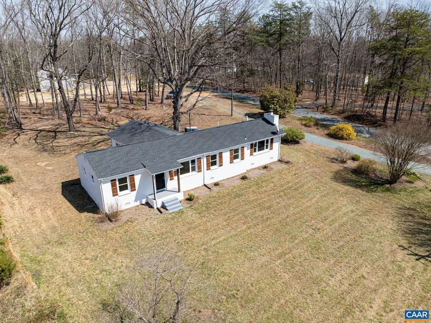 Newly expanded and fully remodeled! This classic brick ranch has been thoughtfully transformed with a brand-new, spacious family room, offering the extra living space today?s buyers crave. Perfectly situated on a flat, landscaped 1.5-acre lot in Louisa, this home delivers true one-level living with a modern, open-concept flow. The heart of the home is the fully updated kitchen, featuring premium granite countertops, crisp white cabinetry, a modern tile backsplash, and stainless steel appliances. This space flows effortlessly into the dining area and the expansive new family room, perfect for entertaining or relaxing. Retreat to the private primary suite, a rare find featuring a cozy wood-burning fireplace, a generous walk-in closet, and a beautifully renovated ensuite bath. Two additional bedrooms with plush new carpet share a second remodeled full bath. Recent upgrades include a high-efficiency heat pump and central AC. Enjoy the ultimate blend of country tranquility and convenient access to Charlottesville!,Granite Counter,White Cabinets,Fireplace in Master Bedroom