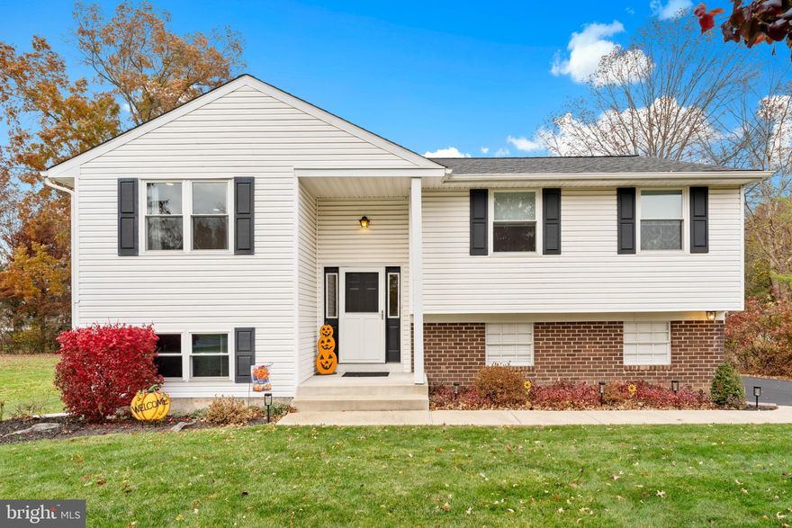 Discover the charm of this delightful bi-level home, nestled on a generous lot, offering a perfect blend of comfort and functionality. This home has been thoughtfully updated while maintaining its traditional appeal. Step inside to find a warm and inviting atmosphere. The updated eat-in kitchen has newer stainless steel appliances and is perfect for family gatherings. With four spacious bedrooms, there's ample room for relaxation and creativity. This home includes one full bathroom and a convenient half bath, ensuring comfort for everyone. The property is highlighted by a lower level with a cozy brick fireplace that serves as the heart of the living space, and an additional room that can be an office or extra bedroom providing versatility to suit your needs. The lower floor laundry area adds practicality to your daily routine, making chores more efficient. Outside, the expansive yard offers endless possibilities for gardening, playing, or simply unwinding. The attached garage provides easy access and additional storage, while the driveway accommodates extra parking for guests. Located in a peaceful setting, offering convenient access to shopping and dining options, as well as top-rated schools nearby. Whether you envision hosting summer barbecues or cozy winter nights by the fire, this home is ready to embrace your lifestyle. Don't miss the opportunity to make this inviting space your own!