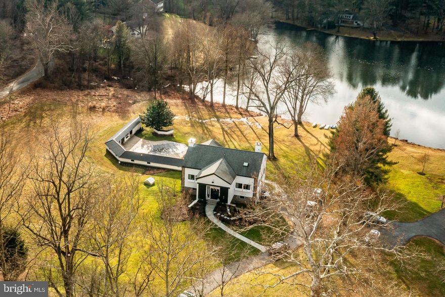 Offer deadline is Monday, January 22nd at 12pm.  Welcome 126 Heyburn Rd., where old world charm meets modern finishes and sophistication.  Located in Hilloch Manor, Chadds Ford Twp, this gorgeous home built in 1840 has been fully updated and remodeled, bringing it to practically brand new!  A unique, one of a kind converted barn residing in the desirable and awards winning, Unionville-Chadds Ford School District! Inground pool and incredible views! Modern and sophisticated, this home boasts 6 bedrooms and 3 full and 3, 1/2 bathrooms, set on almost 3 private acres with not only an inground pool, but overlooking Karver Lake as well! The views from every window are jaw dropping.  On the first floor you will walk into the grand entryway with a 2 story foyer. The primary bedroom is on the main living floor, complete with a wood burning fireplace, and walk in closet, and an inviting en suite featuring a free standing classic soaking tub and handsomely tiled stall shower. A 2nd bedroom is located on this floor, and main floor laundry. The modern kitchen is equipped with stainless steel appliances and upgraded quartz, finished with white custom cabinetry and a large island. Off the kitchen, the dining and family area are bright and cheery with wall to wall, floor to ceiling, glass windows and patio doors leading to the outdoor space. There is a wood burning fireplace in this space as well.  Finishing off this floor is a very generous sunroom overlooking the properties grounds and the lake accessible from the primary suite and the family room.  The 2nd floor has INCREDIBLE LAKE views!  Featuring an office and 3 bedrooms. 2 that adjoin with many possibilities including a 2nd office, a nursery or a dressing room.  The adjoining rooms have a Jack & Jill style full bathroom. The 3rd bedroom upstairs has its own full bath. The basement level is equipped with a 2 car garage and large finished area with a bedroom.  This is a walkout basement with a half bathroom.  Peaceful and serene, the backyard features a converted original space, loaded with storage and serving as a unique and perfect addition to relaxing by the pool.  The structure also includes a full outdoor kitchen and its own outdoor shower and changing station as well as additional laundry room and half bath. This stunning home is a must-see!  Upgrades, details and amenities galore!  You will not find another home like this one!