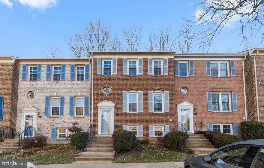 Sunny, stylishly updated and immaculately maintained all brick townhouse with 4 bedrooms and 3.5 baths in desirable Stonehurst is just minutes from I-66 and 495, Vienna Metro, Pan Am Mall and the Mosaic Center! Backing to woods and located in the newest part of Stonehurst (Section IV) the popular Surry IV model features spacious rooms with sunlight filtering through large windows that face East in front and West in back. The main level boasts rich hardwoods and a floor plan that invites family or social gatherings: the large living room connects to a banquet size dining room with built-in china closet and a stunning handmade Italian chandelier! The elegant kitchen has maple cabinets, silestone countertops, ceramic tile floor and eat-in area with box-bay window overlooking the fenced patio below. A powder room and coat closet complete the main level. Upstairs you'll find a large primary suite with dressing area that contains a second sink, big walk in closet as well as an additional closet, all separate from the full bathroom itself. A huge secondary bedroom that spans the entire back of the house with peaceful woodland views has two closets and is served by a recently remodeled bath and linen closet located in the hall adjacent. The lower level contains a third bedroom with closet, a full bath, and a cheerful family room with wood burning fireplace and sliding glass doors to the fenced patio and woods beyond. In addition there's a laundry and utility room with storage space and good storage located under the stairs. Updates include: New roof 2019; New hardwood floors and carpet 2018; Upstairs hall bath remodeled 2018; Dishwasher 2024; Washer (2018)/Dryer(2024) and Refrigerator 2024; HVAC 2008; Windows 2006. Stove/Oven is functional but will be replaced NEW. (Ordered) Two assigned parking spaces are labeled 31XX. In addition to proximity to many commuting, shopping and entertainment options, the Stonehurst community offers walking paths and abundant green space including a large field, tot lots and picnic area. Come see this. Won't last long. (will touch up the wall in a few days)