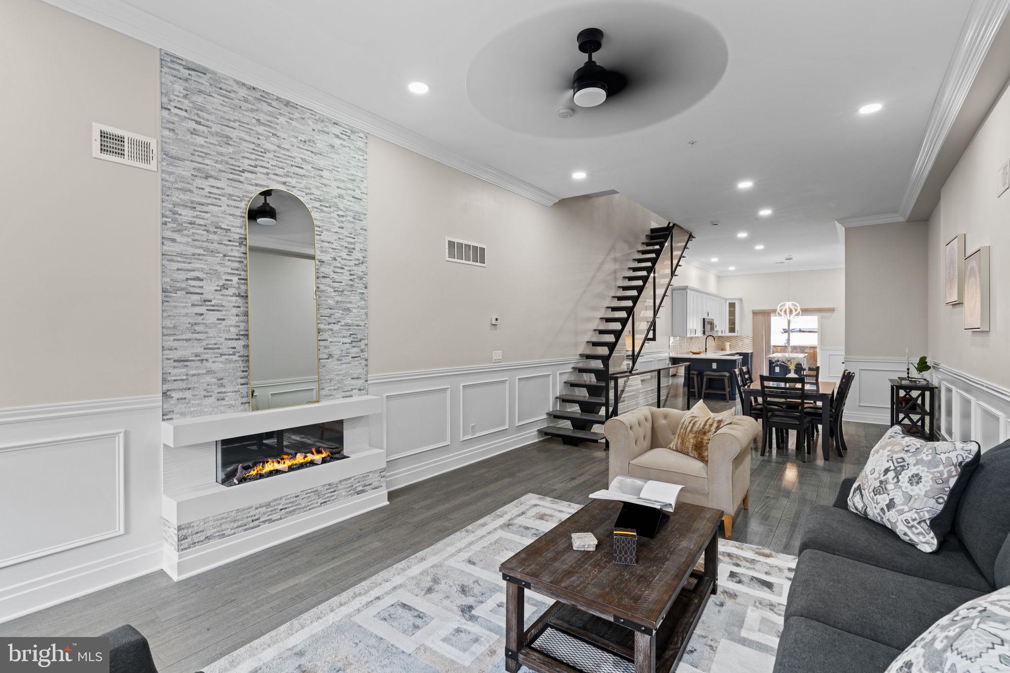 Welcome to The Estates at Queen Village, an exclusive collection of newly constructed townhomes nestled in one of Philadelphia’s most vibrant and historic neighborhoods. Surrounded by tree-lined streets, local boutiques, renowned dining, and cultural landmarks, this exceptional residence offers a rare blend of contemporary luxury and timeless charm all with the advantage of a 10-year tax abatement.
Designed with elevated living in mind, the main level features an expansive open-concept layout that seamlessly connects the living, dining, and kitchen areas ideal for both intimate gatherings and larger-scale entertaining. At the heart of the home is a chef’s kitchen that strikes the perfect balance of function and elegance, complete with quartz countertops, navy blue lower cabinetry, crisp white uppers, and a suite of professional-grade Viking appliances, including a built-in refrigerator and gas range. A substantial center island provides additional prep space, casual seating, and a natural hub for socializing.
The second floor offers two spacious, light-filled bedrooms — each with its own ensuite bathroom — making them perfect for guests, family members, or even a second primary suite. Thoughtfully designed windows flood each room with natural light, highlighting the craftsmanship and openness throughout.
Ascending to the third floor, the home’s crown jewel awaits a private primary suite that exudes serenity and sophistication. This luxurious retreat features a spacious bedroom, a custom walk-in closet, a sleek wet bar, and a spa-inspired ensuite bathroom with a deep soaking tub, glass-enclosed shower, and dual 60-inch vanities. A dedicated laundry room on this level adds ease and convenience to your daily routine.
Atop it all, a full-length rooftop terrace offers panoramic city views and upgraded lighting an ideal space for al fresco entertaining or quiet evenings under the stars.
The finished lower level adds valuable flexibility, perfect for a home office, fitness studio, media room, or guest space. A second laundry area on this floor enhances day-to-day convenience.
This residence isn’t just beautifully designed it’s lifestyle-driven and intentionally crafted for comfort, function, and elegance in the heart of Queen Village. Your luxury urban sanctuary awaits.
1-Car garage available/optional for an additional cost.