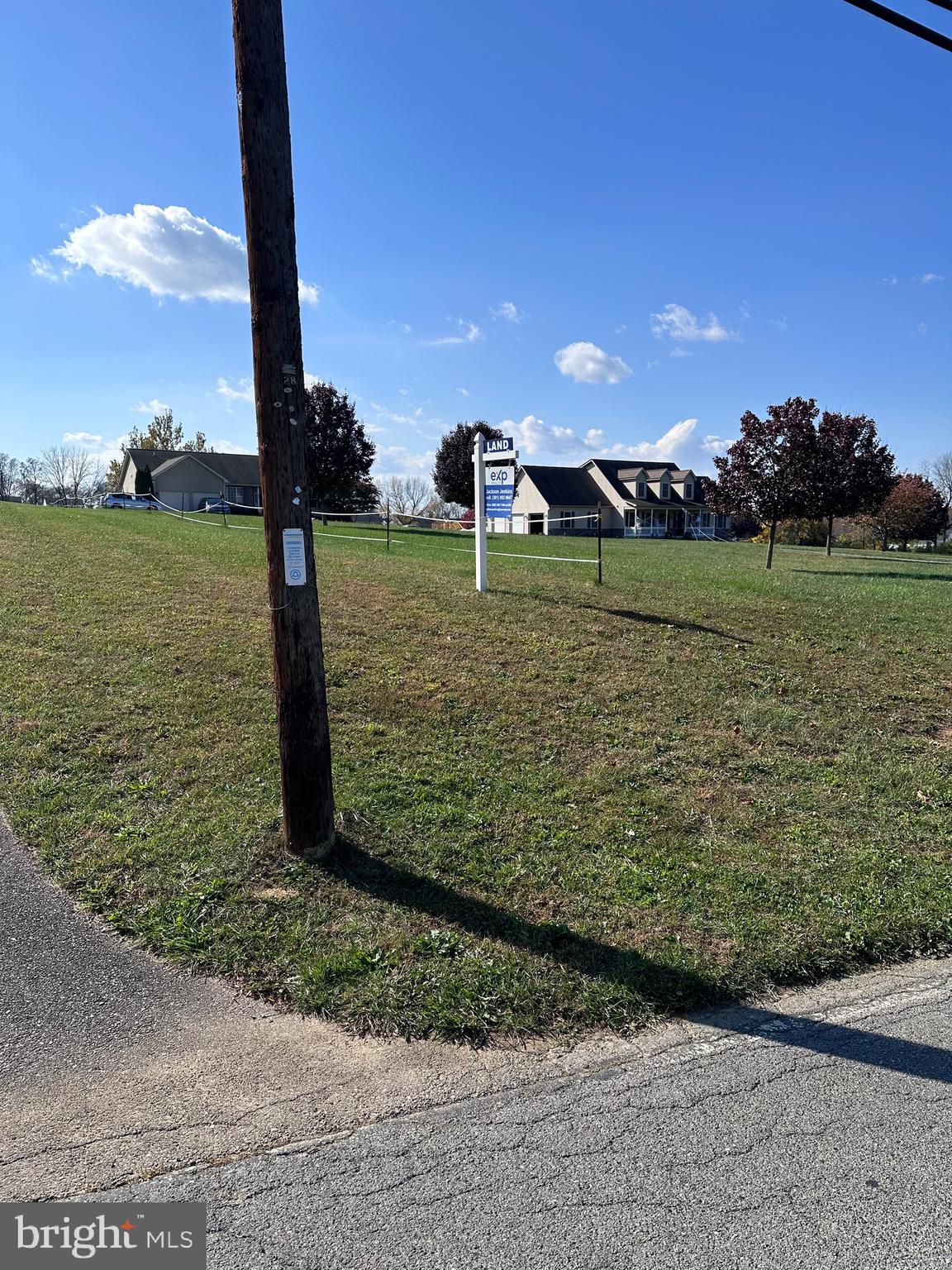1.93 acres of land on sought after Beaver Creek Road. The road will have a driveway that leads behind existing housing. The Real Estate sign sits between a telephone pole and a roped off section that will be the driveway that leads to the very large opening, ready to be built on.