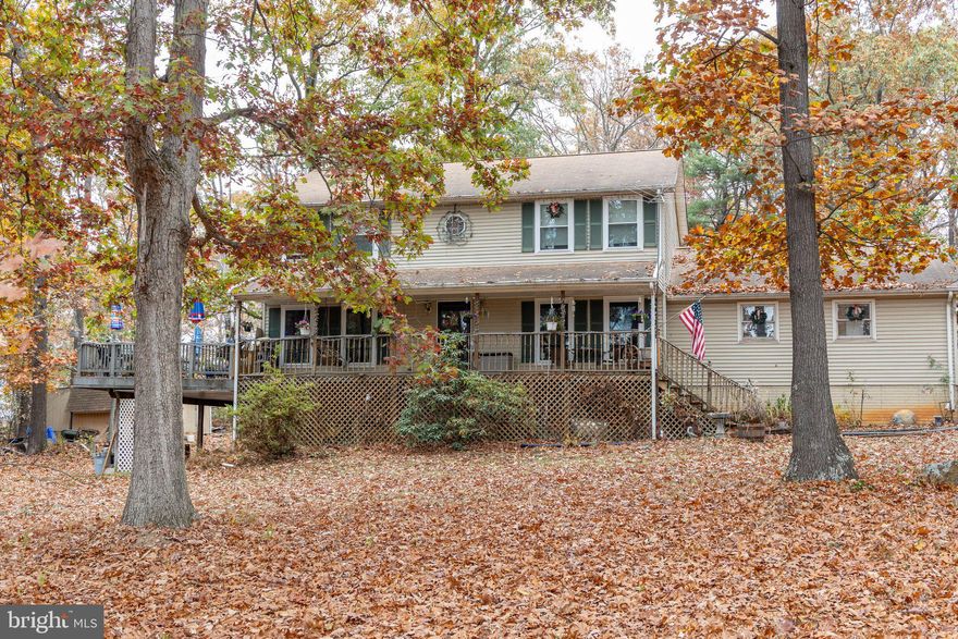 READY TO MOVE - MOTIVATED!   Wooded setting with seasonal distance views. Covered front porch to relax and enjoy morning coffee. Main level features Kitchen, Living Room, 1/2bath and Family Room! Upper levels hosts the primary bedroom & on suite, 3 additional bedrooms and a full bath. Walk-Out Basement offers a den/guest space with full bath. Outbuildings & Fruit Trees. Convenient to Harrisonburg and Route 42.