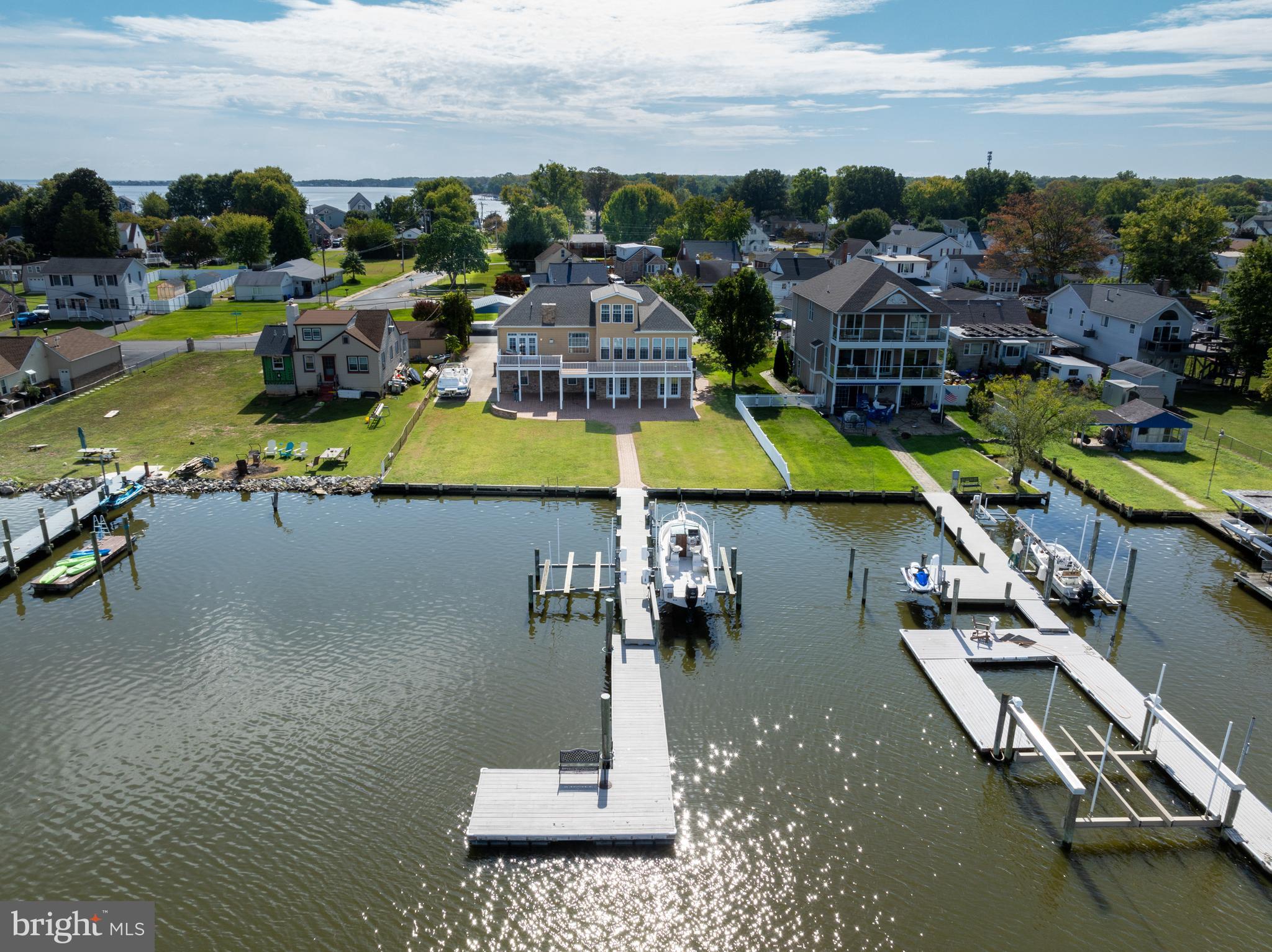 Welcome to 6910 River Drive Road, waterfront living at its finest! This gently lived-in 4-bedroom, 3.5-bathroom home offers an exceptional lifestyle with 85 feet of water frontage, a 104-foot pier, two boat lifts, and a jet ski lift—ideal for the boating enthusiast. Situated on just under a half-acre lot with a 3-car side-loading attached garage, this property provides both luxury and convenience.
Upon arrival, take your private elevator up to the main level, where you’ll be captivated by the spacious Great Room, featuring gleaming hardwood floors, vaulted ceilings, and a cozy gas fireplace—perfect for those chilly winter nights. The kitchen is complete with granite countertops, ample cabinet space with pull-out shelves, recessed lighting, and a large pantry. The adjacent dining area is highlighted by floor-to-ceiling windows that flood the space with natural light and offer breathtaking water views.
Step outside to the expansive party deck, made of low-maintenance composite decking, where you'll enjoy panoramic water views, perfect for entertaining or simply relaxing. The sellers are generously including a stainless-steel grill, adding to the home’s outdoor allure.
The main level also boasts a serene primary suite, with direct access to the deck and water views, along with an en-suite bathroom featuring a separate shower, ample counter space, a large vanity mirror, and a walk-in closet. Two additional spacious bedrooms, a full hall bath with a jet tub, and a laundry room with a full-size washer and dryer complete the main floor.
The upper level features a private 4th bedroom with a full bath and its own ductless split AC system, providing a quiet retreat for guests or family members.
Other notable updates include a newer roof (2022), a tankless water heater, fresh paint throughout, a half bath on the lower level, an inviting front porch, and a large front parking pad with a long driveway—perfect for accommodating guests.
Located close to The Chesapeake Bay, Hart Miller Island, and the Inner Harbor, this home offers easy access to the best of waterfront dining and recreation. Priced to sell, this incredible opportunity won’t last long. Schedule your exclusive showing today and start living the waterfront dream!
