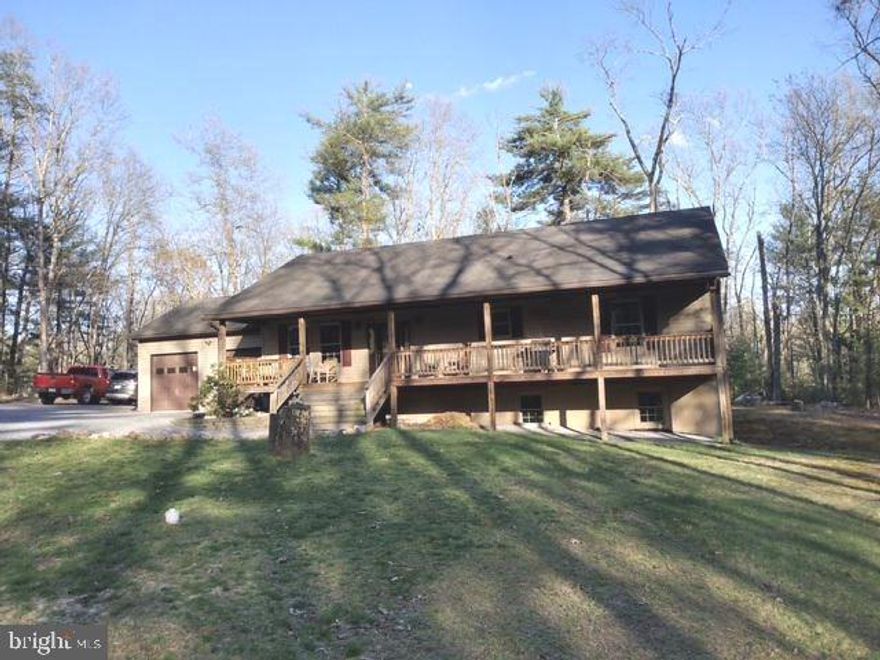 This property will check all the boxes.  The 4+ acre wooded lot offers great privacy, especially from the front covered porch and rear deck.  The lot is mostly level, has a long gravel driveway from  Quaker Woods Lane.  Quaker Woods Lane ends at a cul-de-sac and there are only a few homes along the Lane.  This home has an open floor plan, vaulted ceiling , attached 2 car garage.  The lower level is completely finished with a large familyroom (pellet stove), bedroom, full bath, utility room, laundry room, and what could be the 4th bedroom although no ingress/egress or windows.  The home has been very well maintained.  Pride of ownership will be obvious.  Offering easy access off Dillons Run Road.  10 minutes from Capon Bridge and  30 minutes  from the western edge of Winchester (Medical Center, Walmart).  No stoplights for the last 29 minutes!!  Come take a look.  You will be pleasantly surprised.