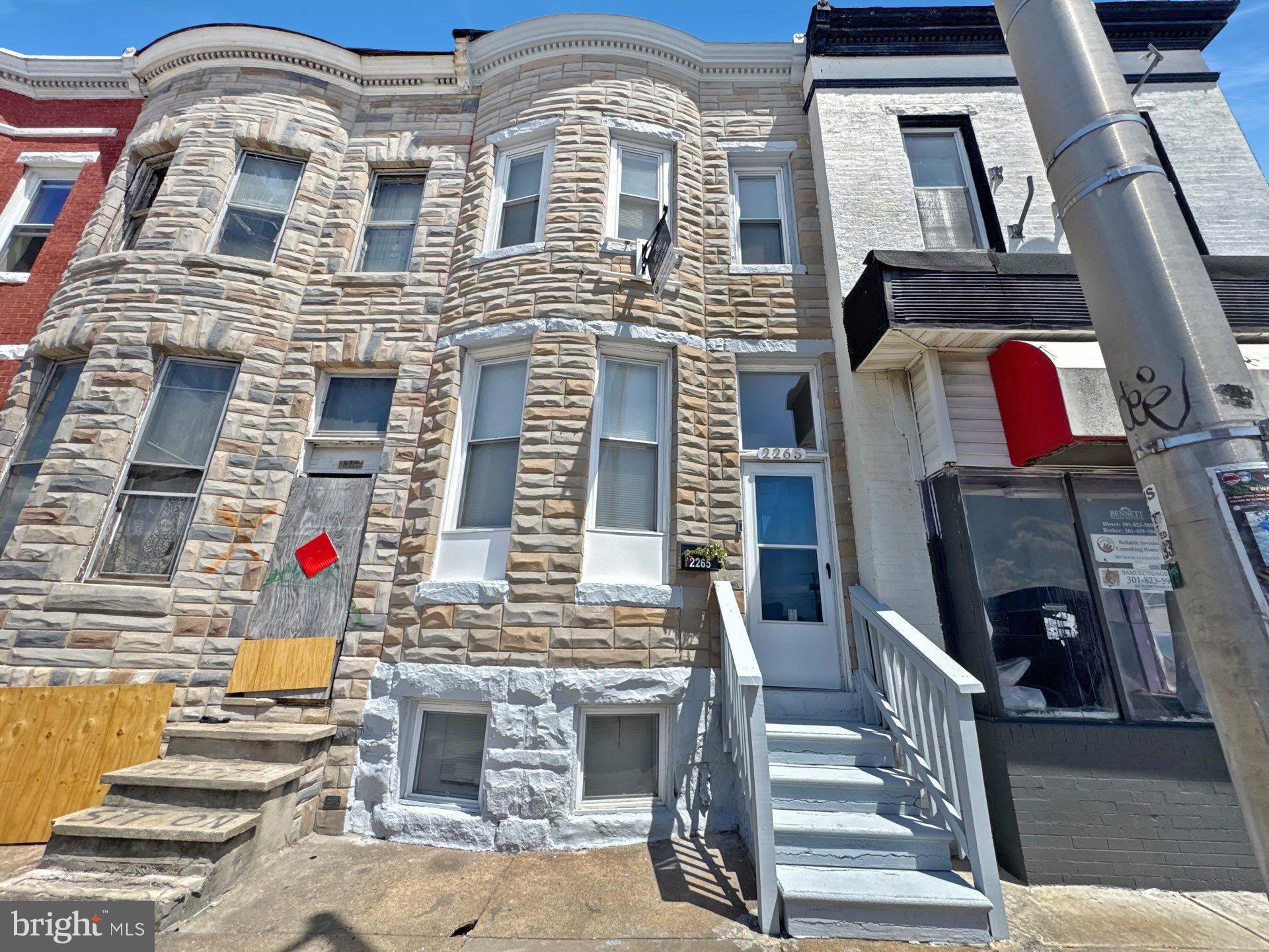 Welcome to 2265 Reisterstown Road, a beautifully updated 5-bedroom, 2-bathroom brick townhome ideally situated in Baltimore’s dynamic Parkview community. Remodeled in 2017 and freshly refreshed in 2025, this spacious residence blends timeless character with modern comfort. The main level features gleaming hardwood floors, a generously sized bedroom and full bathroom, and a large eat-in kitchen outfitted with granite countertops, ample cabinetry, and sleek black and stainless steel appliances—perfect for everyday living and entertaining. Upstairs, you'll find four additional bedrooms with plush wall-to-wall carpeting and a fully remodeled bathroom designed for contemporary comfort. The finished basement expands the living space with a bonus living room area, an additional flex room ideal for an office or guest suite, and a walk-out to the rear of the home. Central heating and cooling ensure year-round comfort, while the new roof (2017) and smart updates throughout provide peace of mind. A private rear parking pad for one vehicle adds convenience. Enjoy easy access to the newly redeveloped Parkview Recreation Center, Mondawmin Mall, metro transit, the Baltimore Zoo, Druid Hill Park Lake redevelopment, neighborhood parks, and the Shops at Mondawmin. Don’t miss your chance to own this turn-key home in a rapidly transforming area.