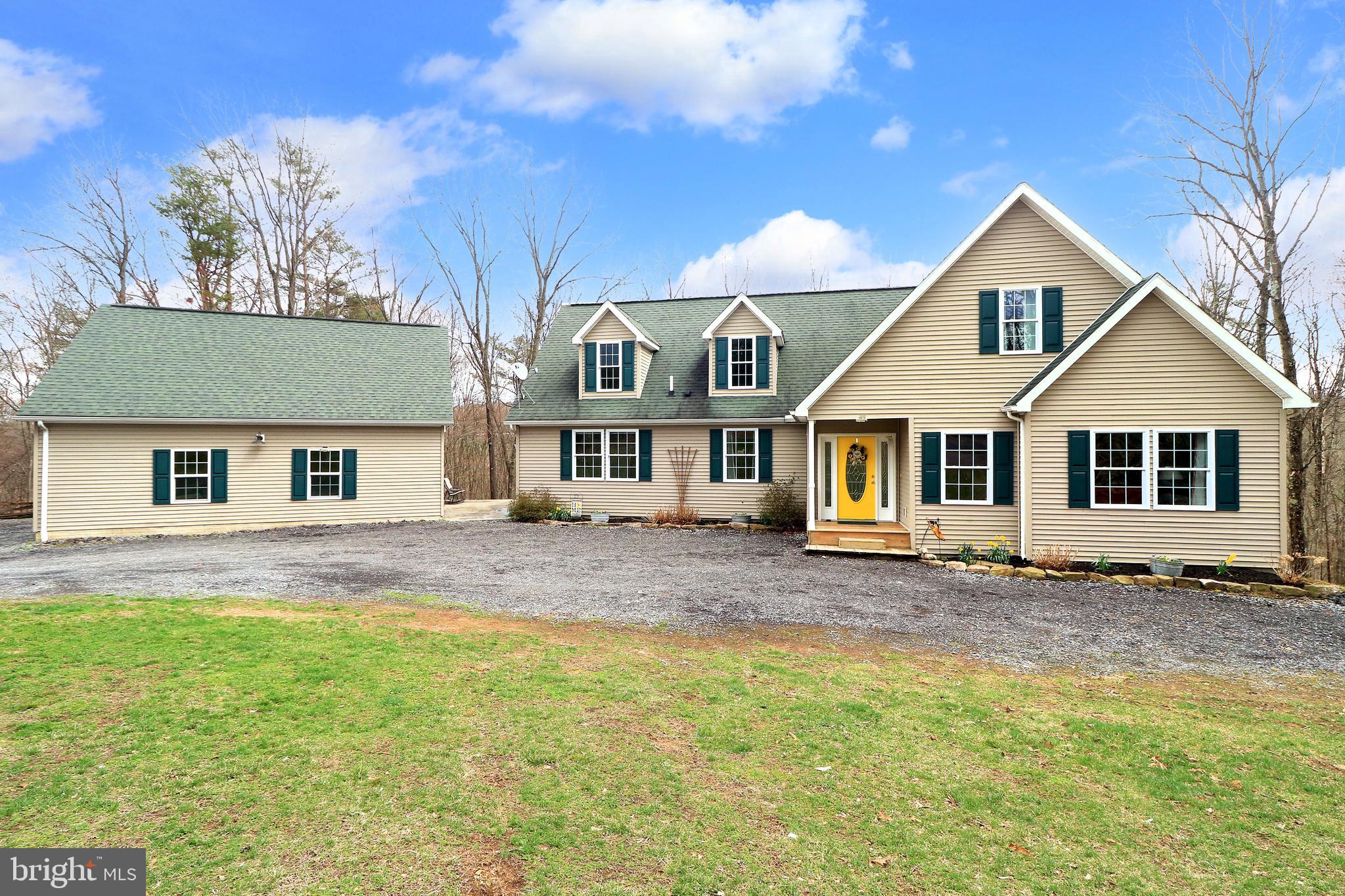 Back on the market through no fault of the seller! The previous buyer was unable to sell their home, creating a new opportunity for you to make this exceptional property yours. Don’t miss your second chance to own this amazing home—schedule your showing today! Cape Cod Charm Meets 14.1 Wooded Acres of Pure Privacy. Nestled on 14.1 secluded acres, this enchanting Cape Cod home offers a perfect blend of solitude, space & modern comfort. Step inside to discover a warm & inviting living room with a cozy corner stone propane fireplace. This space flows effortlessly to the open concept family room, kitchen & dining room area all with hardwood flooring. The family room provides a relaxed atmosphere with ample space for everyone to gather daily, making it an ideal spot for both quiet evenings & lively get-togethers. The beautifully appointed kitchen boasts natural finish oak cabinetry, gorgeous quartz countertops, subway tile back splash, deep stainless sink with a gooseneck faucet, stainless hood range over the gas cook-top & a large island with storage & a darling breakfast bar. The delightful dining room is enhanced by a stylish farmhouse style pendant light fixture & a sliding glass door opens to the composite deck that overlooks the peaceful wooded surroundings. The first-floor owner’s suite is a true haven, featuring 2 walk-in closets & a luxurious private bath with a relaxing soaking tub, tiled walk-in shower & dual vanity. There are 2 additional nicely appointed bedrooms & another full bath on the main floor plus a convenient laundry/mudroom with an exterior door, perfect for muddy paws or shoes. Upstairs you'll find a spacious 22x15 family room, a 20x15 bedroom with a walk-in closet, a full bath & an office currently used as a guest bedroom. The full unfinished basement includes a full bath with knotty pine finished walls & a pedestal sink. With 1500 square feet of unfinished space offering endless possibilities for storage or additional living space. A concrete patio connects the space from the house to the over-sized side load 2 car garage, with a 3rd rear garage door for added functionality. Additional amenities include a radon mitigation system, Brand New Bosch 15 seer 3 ton heat pump & New Bosch 3 ton air handler installed April 2025, refreshing central air conditioning, as well as an outdoor Shaver wood boiler which can be used to heat the water for the house & a supplemental heat source. Conveniently located just 4 miles from downtown Huntingdon, 17 miles from Seven Points Marina at Lake Raystown & 29 miles to State College & Penn State. If you're seeking peaceful seclusion & room to roam, this captivating retreat offers it all. With enchanting charm & breathtaking natural surroundings, this very special property is sure to steal your heart. Get ready to fall in love!