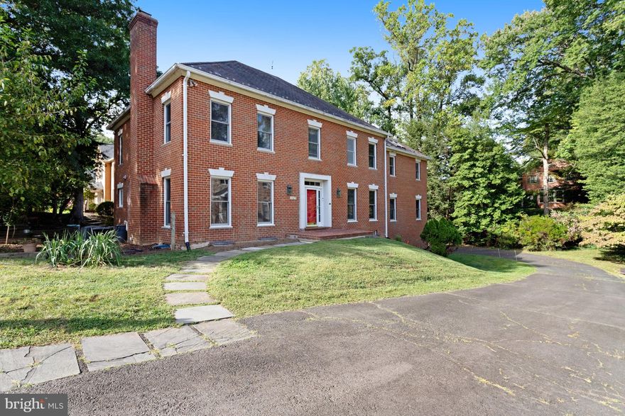This stunning brick Georgian Colonial is filled with natural light and timeless elegance. The grand formal dining and living rooms offer embassy-sized spaces, featuring beautiful hardwood floors, handcrafted American ceramic tiles, and five pairs of French doors leading from the stately gallery. With 10-foot ceilings, expansive windows, crown and dentil moldings, and a marble-hearth fireplace in the living room, the home exudes classic charm. A step-down library with intricate moldings includes a custom bar crafted from 19th-century French woodwork and shelving made from a 200-year-old red oak sourced from the property itself. The main level continues with a formal dining room showcasing a second fireplace framed in stunning White Mariposa marble. The chef’s kitchen boasts a center island, Corian countertops, stainless steel appliances, two prep sinks, a gas stove and oven, breakfast area, butler’s pantry, and a bay window leading to the new Trex deck—perfect for outdoor entertaining. The upper level offers a beatiful primary suite, with the  a sitting room, a cozy Azul Baia Brazilian blue marble fireplace, a kitchenette, and a Juliet balcony. The suite flows into a master dressing room with built-ins and a spa-like bath, complete with a whirlpool tub, dual vanities, bidet, double shower heads, and a skylight. Three additional spacious bedrooms, ample closet storage, and a separate electric hot water heater complete this level. The light-filled walkout lower level boasts a fifth fireplace, a raised Virginia Pine platform, a third wet bar and kitchenette, a full bath, a wine cellar with racks made from the same 200-year-old red oak, and new luxury vinyl plank flooring. The lower level opens directly to the rear patio and deck, providing seamless indoor-outdoor living. Additional highlights include a utility room with new GE washer and dryer, wiring for a potential spa, dual-zone heat pump system, two hot water systems (gas and electric), and an upgraded 400 amp electrical panel. The property is surrounded by mature landscaping, including fruit trees, raised garden beds, and outdoor lighting. The western property boundary has historical significance, marking part of George Washington’s survey and the Arlington-McLean line, with Civil War artifacts discovered on site. Located less than a mile from Washington Golf and Country Club, Marymount University, and Jamestown Elementary, this home offers a prime location with easy access to shops, dining, and major commuter routes. A Commuters Dream!