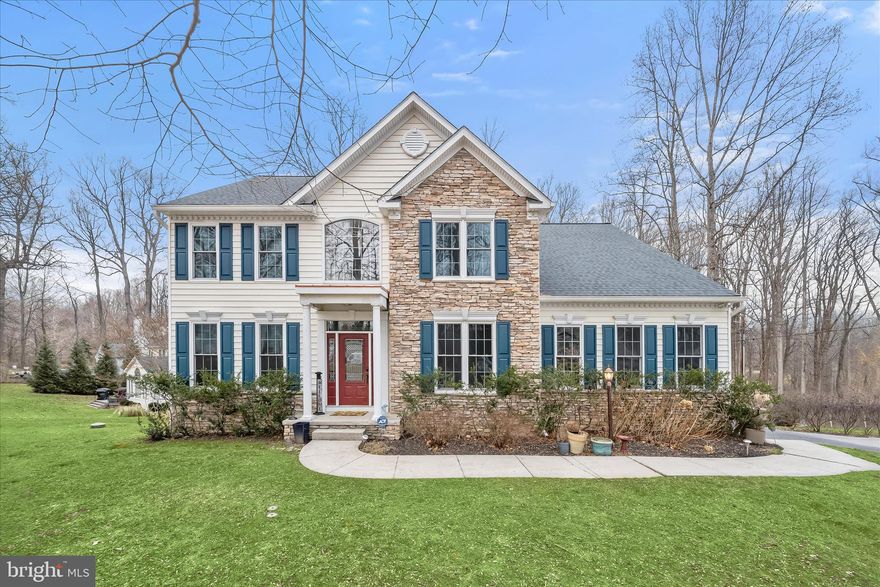 Lovingly maintained and beautifully situated in a peaceful, wooded neighborhood, this exceptional home offers privacy, natural beauty, and a thoughtfully designed layout ideal for both everyday living and entertaining. Nestled among mature trees within the David Force National Resource Area, the property provides a tranquil retreat while remaining conveniently located for commuters.  A bright two-story foyer welcomes you into the home, leading to an open and functional kitchen featuring a cooktop, wall oven, microwave, 42-inch cabinetry, center island, and pantry. The kitchen opens to a step-down, expanded family room highlighted by a propane gas fireplace with mantel and an impressive wall of windows that fills the space with natural light. Hardwood flooring enhances both the main and upper levels, with worn areas scheduled to be refinished prior to settlement. Main-level laundry adds everyday convenience.  Formal living and dining rooms offer elegant spaces for gatherings, with large windows and a charming bay window in the dining room. A dedicated home office on the main level, accessed through French doors with glass inserts, provides a quiet and light-filled workspace.  From the kitchen’s eat-in area, sliding doors lead to a deck, flagstone patio, and walkway overlooking the serene wooded landscape, perfect for enjoying outdoor living in a natural setting.  Upstairs, an open landing leads to three generously sized bedrooms and a hall bathroom with dual vanities. The expansive primary suite features two walk-in closets and a luxurious en-suite bath with dual vanities, a soaking tub ideal for relaxation, and an additional linen closet.  The fully finished lower level extends the living space with a large recreation area, full bathroom, exercise room with Pergo flooring and mirrored walls, and abundant storage in three separate enclosed areas. Walk-out sliders open to a stone patio and decorative dry creek riverbed. An additional spacious room currently serves as guest accommodations, offering excellent flexibility.  Additional features include a storage shed with a newer roof, originally designed as a playhouse with carpeted floors and painted drywall, and a fully installed and operational invisible fence encompassing the property. Major updates include a new roof (2024), water heater (2024), replacement windows (2021), and dual HVAC systems installed in 2018.  Ideally located near Route 40, I-70, and US-29, this home offers the perfect balance of commuter convenience and peaceful surroundings. Tucked away at the end of the lane, this is a rare opportunity to enjoy a serene setting without sacrificing accessibility.