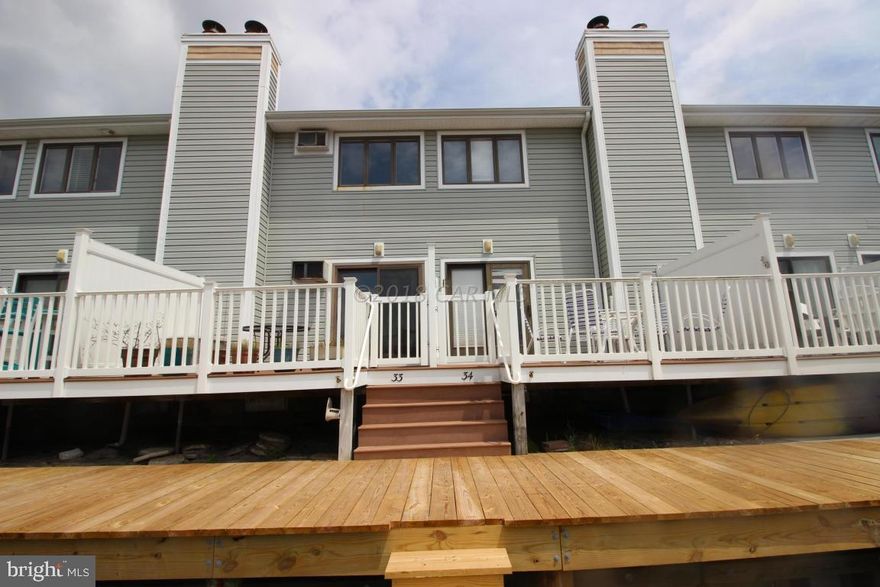 One of a kind community at Nassau Village in Little Salisbury. 2 bedroom 1 1/2 bath townhome featuring huge outdoor pool, direct west facing waterfront condo on wide canal with views of the large lagoon including your own boat slip. Fully furnished and ready to move in. Wonderful midtown location at 93rd street close to shopping, restaurants, dog park, basketball and tennis courts, Art league and short walk to the pristine beaches at 93rd street. Great for biking around the local neighborhood, close to public boat ramp, boat trailer parking lot.  Well run condo association with large reserves, low condo fees, owners take pride in ownership in this close community of beach and water lovers. Great protected large lagoon for kayaking, paddle boarding, floating, boating, crabbing, fishing.