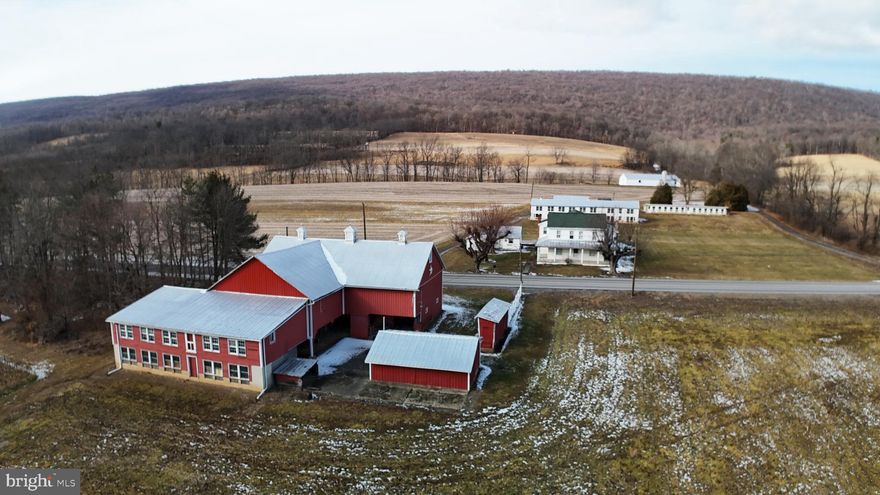 This property is going to onsite auction 4/19/2025 at and is being sold with reserve. LISTED PRICE IS ONLY A SUGGESTED OPENING BID AND IS NOT INDICATIVE OF THE FINAL SALES PRICE WHICH WILL BE BY SELLER CONFIRMATION DAY OF AUCTION. Terms: Down payment of $70,000 required day of auction. Settlement on or before 5/30/2025. Transfer taxes to be paid by buyer. Real Estate taxes shall be prorated.
Discover the ultimate blend of productive farmland and serene country living on this remarkable 69.8-acre estate. Perfectly suited for the discerning farmer, hunting enthusiast, or anyone seeking a peaceful rural retreat, this property offers an impressive array of features and endless possibilities.
Situated in scenic Raccoon Valley,  there are 52 acres of productive farmland ready for cultivation or expansion of your agricultural pursuits. With natural water features, you can enjoy a year-round, spring-fed creek along with a stocked trout stream. Raccoon Creek meanders through the property, adding both scenic beauty and recreational opportunities. Enjoy superb hunting  with 12 acres of mature woods, perfect for privacy, wildlife, and excellent hunting opportunities from the enclosed tree stands overlooking the fields. Substantial outbuildings include a large bank barn, ideal for storage, livestock, or other agricultural operations., a spacious 20' x 90' two-story chicken house, a 14' x 78' single-story chicken house, a 40' x 75' shed provides abundant space for equipment and additional storage.
Additional Outbuildings: Numerous structures, including a useful summer kitchen, add to the property's functionality and character. A 6 bedroom, 2 bath farmhouse with a wraparound covered porch, and an attached heated 2-car garage gives comfortable living quarters. Whether you’re looking to expand your farming operations, recreation, hunting, or simply unwind by the water, this property caters to all lifestyles. With its unique combination of productive land, diverse outbuildings, and abundant natural resources, this estate is a rare find that promises both practical benefits and an exceptional quality of life.
Don’t miss the opportunity to experience this extraordinary property—schedule your private tour today and explore the endless potential that awaits!