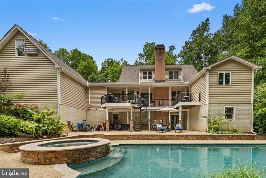 Tucked away in a setting of complete privacy, this captivating residence is a rare offering where charm, craftsmanship, and thoughtful upgrades come together effortlessly. Meticulously maintained and curated with intention, every space tells a story—one of quality, comfort, and timeless design. From the moment you enter, the home reveals its character through exquisite details: custom built-ins, carved wood ceilings, and beautifully refinished hardwood flooring that flows throughout. The heart of the home is both inviting and refined, anchored by a striking Wolf stove and complemented by a cozy fireplace and soaring vaulted ceilings. Designed for both everyday living and exceptional entertaining, the main level features two full baths, including a serene primary suite that offers a true retreat. Upstairs, you’ll find a private bedroom with its own en-suite bath, along with two additional bedrooms—one thoughtfully designed with a hand-painted forest mural, creating a whimsical and memorable space. Adding to the property’s versatility is a finished garage with a dedicated studio/workspace and a complete guest suite above, offering a full bath, bedroom, and separate work area—ideal for extended stays, creative pursuits, or private accommodations. The lower level has been recently finished, providing additional living space with a bedroom, expansive recreation or fitness area, and a convenient half bath with direct access to the outdoor amenities. Step outside and experience a true resort-like setting. The saltwater pool, just four years old, features a PebbleTec finish and a built-in spa, surrounded by extensive landscape lighting and color-changing pool illumination—creating an atmosphere that transitions seamlessly from day to evening. Ample parking and a large storage building ensure both function and convenience. Located less than an hour from Washington, D.C. and Annapolis, Maryland, this property offers the perfect balance of seclusion and accessibility. A private retreat of uncommon quality—designed to restore, inspire, and elevate everyday living.