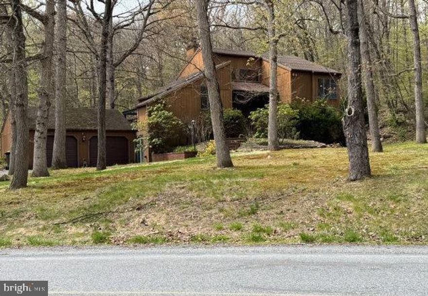 Don't wait to see this 3 or 4 Bedroom Contemporary in a wooded setting. The 4th bedroom is presently being used as a living room for guest quarters that also has a bedroom, bathroom, and a kitchenette. That living room can easily be used as the 4th bedroom with a bathroom between bedroom 3 & 4 and a kitchenette for evening snacks. The living room has a fireplace and a sliding glass door that leads to a large wrap around deck. Sit on the deck to enjoy the wooded setting that looks at the hot tub and pool. The pool, filter, heater, and hot tub have not been used for up to 10 years and are in "as is" condition. The eating area has room for a table PLUS there is a breakfast bar to have a quick meal. The kitchen includes a dishwaher, range, and Jennaire. The second level has 2 more bedrooms.  Between the bedrooms there is a laundry room/ bathroom combination. The basement could be finished for additional living space if you desire more room. This home has everything you need and is waiting for you to do any updates you desire to make it your own. Don't delay, see it today!
