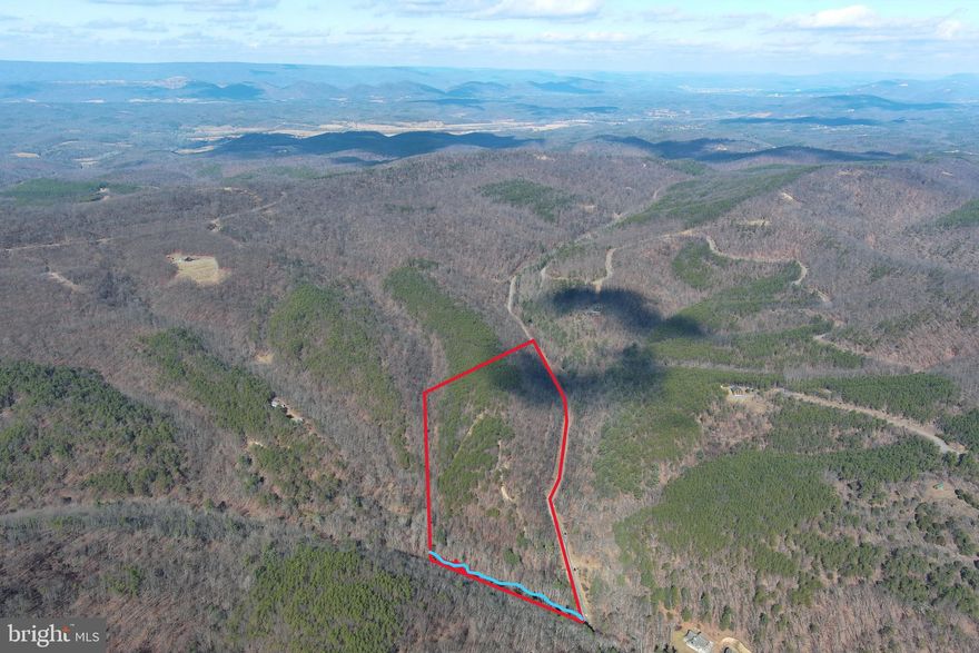 HAPPY TRAILS....21 WOODED ACRES THAT CHECKS EVERY BOX......STREAM, MOUNTAIN VIEWS, GENTLE TOPO AND 1 MILE INTERNAL ROAD NETWORK! LITERALLY A MILE OF TRAILS ON THIS PROPERTY FOR ATV RIDING AND TO USE AS YOUR DRIVEWAY TO THE PRIVATE RIDGE TOP BUILD SITE WHICH OFFERS GREAT MOUNTAIN VIEWS. GENTLY ROLLING FOREST WITH GREAT MIX OF PINES & HARDWOODS. CLEARED CAMP SITE HIDDEN ON THE RIDGE......EASY TO GET TO BUT HARD TO FIND.....ONLY 1.5 MILES OFF THE PAVED ROAD AND JUST UNDER A MILE FROM PRIVATE RIVER ACCESS.....15 MINUTES TO ROMNEY OR FORT ASHBY. ABSOLUTELY LOADED WITH GAME AND "BROAD RUN" FLOWS THROUGH THE FRONT OF THE PROPERTY....YOU'RE  20K AHEAD OF THE GAME ON INFRASTRUCTURE COSTS WITH THE ROADS THAT ARE ALREADY IN PLACE. POWER & PERKED.... LOCATED IN THE PRESTIGIOUS COMMUNITY OF "THE BLUFFS ON THE POTOMAC".....THE BLUFFS IS KNOWN FOR IT'S ABUNDANCE OF BIG BUCKS, BEAR & TURKEY. AS AN ADDED BONUS, THE COMMUNITY HAS IT'S OWN PRIVATE COMMON AREA ON THE SOUTH BRANCH OF THE POTOMAC RIVER FOR CANOE, KAYAK, TUBES, FISH & SWIM......A PRIVATE PARK ON THE RIVER FOR YOUR SUMMERTIME ENJOYMENT. BUILD, CAMP, HUNT, HIKE, ATV'S, SHOOT......ENDLESS OUTDOOR ACTIVITIES AT YOUR FINGERTIPS.....A UNIQUE LOT THAT HAS EVERYTHING ON YOUR WISH LIST....HURRY....THIS ONE'S GONNA DISAPPEAR FASTER THAN A POPSICLE IN JULY!