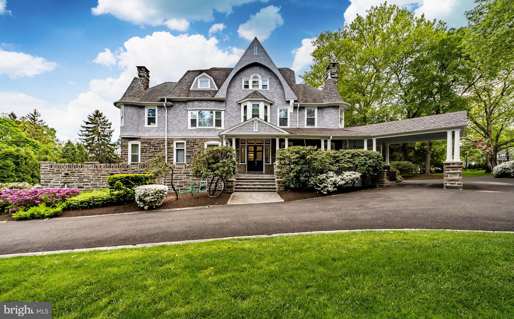 If you’re looking for a truly unique home with endless character, your seach is over. Welcome to Heyghton, historic Wyncote country estate circa 1895, with tasteful updates that bring this Gilded Age mansion into the 21st century. Designed and built by internationally acclaimed architect Horace Trumbauer, situated on nearly 2 idyllic acres just minutes from Philadelphia. This incredible Shingle-Style Victorian is brimming with marvelous architectural details you’d never find in new construction: hand cut, locally quarried stone, wraparound porch with porte cochere, gambrels, turrets, copper roofs, palladian windows, and four fireplaces. This home is a font of artisan craftsmanship. Once on the property, you are greeted by a vestibule with paneled walls and original dentil trim. Open the doors, and the high ceilings and large, wrought iron staircase with dragon detailing give this home a very special feel. To the right is the parlor, with twin built-ins, crown molding, fireplace, and storage closet which currently houses AV equipment for the home’s audio system. Across the hall, behind two immense pocket doors is the drawing room. Note the concentric quartersawn oak floors, original plaster detail-work, coved ceiling, and Italian marble fireplace with dragon mosaic motif. Connected to the drawing room is the dining room, where you will find more plaster-work, coved ceiling, quartersawn oak floors and pocket doors, set off by a beautifully delicate abalone chandelier. Connecting the dining room to the kitchen is a highly functional butler’s pantry with endless storage, blue pearl granite counter and prep sink. The home’s stone work has been incorporated into the renovated kitchen, which features a Sub Zero refrigerator, Kitchenaid dishwasher, and high-end Samsung dual-fuel double oven. There’s a porcelain glazed cast iron sink, additional prep sink, and custom cabinets with under & above cabinet lighting. Moving through the kitchen brings you to the scullery with access outdoors, and even more cabinets and storage. The first floor also features a lovely powder room, more closets, and side entry to the home, along with a back servant’s staircase with original hand carved newel post and banister. Upstairs, the first of the large bedrooms (currently serving as a studio) features a turret and fireplace. A second bedroom suite has a wall of closets, and a Jack and Jill bathroom. The first owner’s suite is enveloped with light from the massive bow window, with a private bathroom, and a hall leading to an additional bedroom. Future owners may be interested in turning this bedroom into a sitting room, as it also features a turret and fireplace, and would make an excellent space to relax. The SECOND owner’s suite has a sitting area, private bathroom, and a soaring, vaulted wood-beam ceiling in the bedroom area. On to the third floor, there are two more bedrooms and two more bathrooms, along with the billiard room. With seemingly endless space, this house would also make for marvelous multi-generational living. But you’re not done yet. The basement also has a sizable living area, with kitchenette, mechanical room, storage room, and access to outside. Cancel your country club membership, because you have one in your backyard. The aforementioned swimming pool and hot tub, surrounded by lush, botanical landscaping will be the envy of all your friends. The expansive wraparound deck has been added with great care to ensure it blends seamlessly with the original construction of the home to add two additional levels of outdoor living. A wraparound bar is the entertaining star, with an additional kitchenette and powder room, so that guests need not enter the main house with wet feet. This astounding home makes life easier by being minutes from major highways and regional rail as well as shopping and dining. Why make compromises when you can have it all?