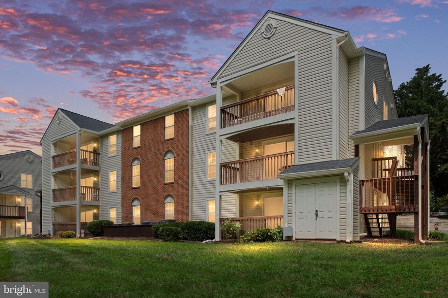 Location, Location, Location.  Rolling Oaks is conveniently located within Blocks to Down Town Manassas, Shopping, Commuter lots/Access, Restaurants, VRE -Manassas Line and within 20 miles to Dulles Airport.
This Ground Level Corner Unit boasts 1 level living with 936 sq.ft., 2 bedrooms, 1 den/office/flex room, 2 full bathrooms, Hardwood Foyer, Kitchen with Stainless Steel Appliances, Granite counters, Hardwood Flooring, Large window for ample Natural Light, Café style opening for access and view into Dining and Living Area. The Large Sliding Glass door in Living Room views and leads to your oversized Deck backing to serene Wooded Tree line and Nature Trail.  Private Secure Storage Closet is accessible from Deck.   Primary Bedroom includes a Walk-In Closet and private Full Bath with Ceramic Tile Shower. Ceramic Tile flooring in both Bathrooms. 2nd Full Bath with Tub/Shower combination.  Utility Room includes Full sized Stacked GE Washer/Dryer. Neutral Paint Throughout. **All electric** Newer HVAC, Newer H2O,