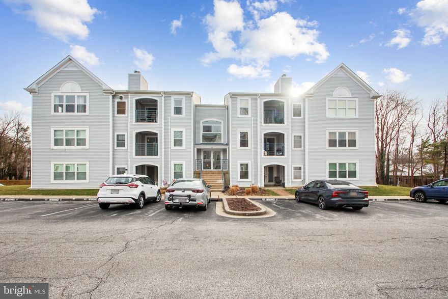This beautiful first-floor 2BR/2BA condo in Annapolis Overlook unit has been updated with new carpet throughout, new LVP in the foyer, kitchen, and bathrooms, and fresh paint to make this unit move-in ready! Updated appliances include a dishwasher and garbage disposal (2023), a Washer/dryer (stacked unit), and a Refrigerator and Stove (2022). The primary bedroom has an ensuite bathroom and a walk-in closet. This open floor unit brings Natural lighting throughout. Walk outside from the living area to your ground-level patio, or relax with your corner wood-burning fireplace. The common front foyer has space for bike storage. One assigned parking spot is located right outside the entrance to your secured building—ample parking for additional cars or guests. The community has a pool and clubhouse. This home is convenient for shopping and restaurants, just a few miles from Downtown Annapolis and the United States Naval Academy. PLEASE TAKE OFF YOUR SHOES