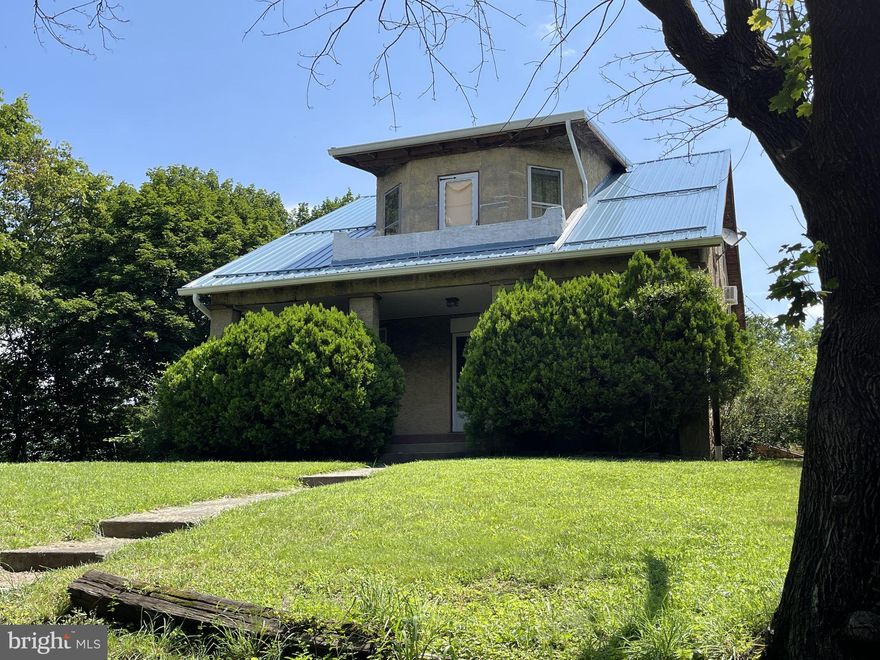 Brilliant Investment!  Ready for your next successful project?!  Look no further!  This is truly the House-on-top-of-the-Hill overlooking the City of Cumberland.   Through the tree-tops you can actually see the water tower at Bishop Walsh!   From the second level balcony the panoramic view must be incredible.  What a unique location!  Use your imagination and see the potential in this property.  Back "in the day" it was said that this house was a admired landmark.    The Home boasts 4 bedrooms and 2 Full Baths (The roof was replaced after damage was done, both need rehab).  The basement is dry and has  laundry and a workshop.  Check it out!