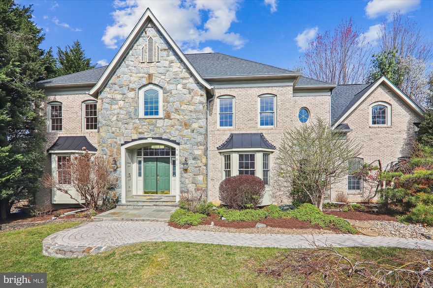 The gorgeous stone and brick facade surrounded by lush landscaping is the perfect prelude to the elegant interior of this expansive 5 bedroom, 4.5 bathrooms home.  

The grand 2-story foyer with chair railing and crown molding showcases the graceful curved staircase and leads to the most marvelous spaces imaginable.  Behind French doors is the large formal living room with bay window. The formal dining room is equally impressive with chair railing, crown molding and a second bay window. The great gathering place, the kitchen, will impress family and guests alike with its welcoming spaciousness, beautiful and plentiful rich-toned cabinetry, center island with grill, shelving and wine storage, stainless steel appliances, desk area and a wonderfully sunlit and enormous breakfast area with bay window, skylights and ceiling fan and deck access. Open to the breakfast room is the 2-story family room offering the most appealing site for comfortable and casual companionship with its floor to ceiling stone fireplace and tall windows.  Off the family room, highlighted by decorative pillars, is the perfect sitting room or office space with a second entry to the lovely rear multi-level deck with gazebo.  The well-designed laundry room and the desired powder room complete the perfect main level of this perfect home.

The stunning upper level landing allows you to enjoy the view into the foyer and the family room.  You’ll also find 4 bedrooms and 3 full baths, including the ideal guest suite with private bath and the huge primary suite with 2 walk-in closets, sitting room with skylights and the luxury bathroom. 

More space for fun is found on the walkout lower level with its large recreation room with fireplace, well designed bar with a second kitchen and a wine cellar.  The 5th bedroom is also here along with another full bath.  Storage space is amazing, too.

Nestled on a tree-lined street in a fabulous, beloved community, this property is also close to all the shopping, dining, entertainment and commuter routes you need.