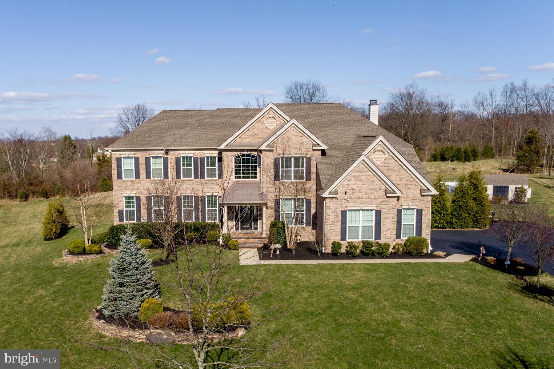 A fantastic and meticulously maintained home in the desirable Preserve at Hilltown development. As you enter the front door you are greeted by the stunning two story foyer and turned stairway. The quality and luxury are immediately apparent with all the finishing touches and appointments including the extensive wainscoting and wide crown moldings. On your left is the formal living room which opens to the large dining room. The true heart of this home is the expanded Palladian kitchen featuring an abundance of cherry cabinetry, beautiful upgraded granite and a full suite of upgraded Jenn-Air appliances. Triple casement windows in the kitchen bring in plenty of natural sunshine. The additional large dining/breakfast area not only provides convenience for meals but is the perfect wide open transition to the magnificent two story family room. The full wall of windows gives you a perfect view of the natural outdoors and the floor to ceiling gas fireplace adds comfort. Stunning custom built-ins flank both sides of the fireplace. The hand scraped hickory floors throughout the main level will also impress you. The main level is also expanded providing even more space to the family room and kitchen. A large two level expansion is finished with a full bath and walk in closet, making it ideal for a first floor Guest Suite, or any other flexible space to suit your needs. A main floor office with custom built-ins and matching desk provides a great option to work from home. A very nicely upgraded powder room and a convenient main level laundry room complete the first floor. Upstairs, the primary suite boasts a trey ceiling, includes a luxurious bath, a sitting area and an exceptionally large walk in closet with organizers. The second bedroom includes a walk in closet and its’ own full bath. The third bedroom shares a jack ‘n jill bath with the exceptionally large fourth bedroom which has two walk in closets. The fifth bedroom includes yet another full bath. The finished walkout basement with a wet bar provides extensive extra space for relaxing and entertaining, and includes a convenient powder room. Out back, you will enjoy relaxing on your covered maintenance free deck or step down to the hardscaped patios to enjoy the natural surroundings and to relax around the fire pit. The spacious garden shed provides plenty of room for your outdoor and gardening needs, and the garden gives you plenty of room to grow your own fresh greens! Quality and comfort abound throughout and you will enjoy the beauty and serenity of Bucks County including parks, lakes, museums, shopping, dining and entertainment. Just minutes from historic Doylestown and major commuter routes.