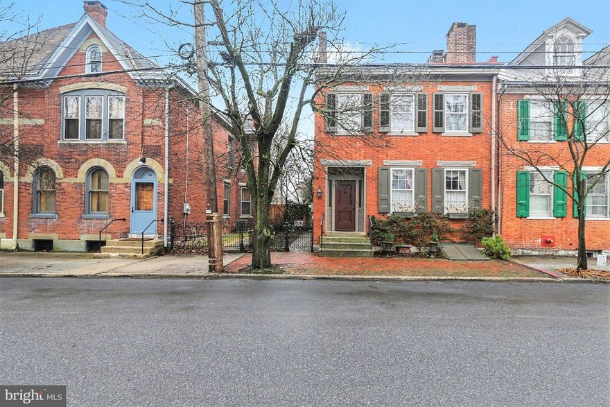 Step into a piece of Carlisle’s history at 136 W Pomfret Street. This beautifully restored 4-bedroom, 2.5-bath home blends historic character with thoughtful updates, preserving its architectural integrity while offering comfortable everyday living. A carefully curated color palette and well-designed spaces allow every room to shine, creating a home that feels both timeless and livable.

Inside, charming architectural details bring warmth and character throughout. The formal living and dining areas provide classic gathering spaces, while a beautiful second living area - thoughtfully added to the home—offers a bright and inviting place to relax, entertain, or spend time with family. The layout provides both elegance and flexibility, allowing the home to function beautifully for modern living.

Once in full bloom, the yard becomes truly stunning. Dogwoods, hydrangeas, redbuds, southern magnolias, crepe myrtles, and a peaceful koi pond create a private garden retreat that feels tucked away, yet you are right in the heart of town. The thoughtfully designed outdoor space features two charming patio areas surrounded by beautiful landscaping and a peaceful pond, creating a private setting perfect for relaxing or entertaining. The accessible backyard and rare two-car garage offer a level of convenience that is hard to find in downtown Carlisle.

Located just steps from the library, YMCA, and Carlisle’s beloved downtown coffee shops and restaurants, this home offers a truly walkable lifestyle. Dickinson College and Law School is an easy stroll, and the Carlisle Barracks is just a few minutes away. Situated within Carlisle Areas School District and a short walk to Mooreland Elementary School, the location combines charm, convenience, and community.

Lovingly restored over the years with careful attention to historic accuracy, this well-maintained property reflects thoughtful stewardship and pride of ownership. Every detail contributes to a home that feels both timeless and welcoming - a rare opportunity to own a truly special property in one of Carlisle’s most desirable downtown settings.