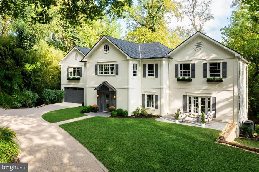 Set far back from the street, 2913 University Terrace NW is introduced by an impressive private driveway and situated on an over half-acre lot, offering exceptional privacy and security in the heart of Kent.

This elegant estate residence is turnkey and features high ceilings, beautiful moldings, hardwood floors throughout, and a thoughtfully designed floor plan. A limestone center hall with a powder room and coat closet leads to a spacious formal sitting room and a grand dining room with French doors that open to a sunny deck.

The expansive living room is ideal for entertaining and includes a fireplace, double French doors to a Juliet balcony overlooking the rear yard, and additional French doors opening to the front yard. The modern kitchen is outfitted with high-end appliances, French limestone countertops, a center island, and ample space for a cozy family area. A main-level laundry room and access to the attached two-car garage complete this floor.

Upstairs, the private primary suite offers a fireplace and an oversized walk-in closet. Four additional bedrooms and three full bathrooms provide generous accommodations for family and guests.
The finished lower level includes a large recreation room with limestone floors, a gas fireplace, and direct access to the backyard. This level also features an en-suite bedroom with a walk-in closet, ideal for guests or live-in staff.

Located in the sought-after Kent neighborhood of Washington, D.C., 2913 University Terrace NW is just steps from local cafes and coffee shops along MacArthur Boulevard. Serene and picturesque, Kent sits on D.C.’s northwestern edge, bordering the wooded trails of Battery Kemble Park. The neighborhood is centrally located between MacArthur Boulevard and Loughboro Road, with Maryland and Virginia just minutes away, offering both tranquility and accessibility.

The expansive lot, private setting, and generous off-street parking make 2913 University Terrace one of the most exceptional estate opportunities in Washington.