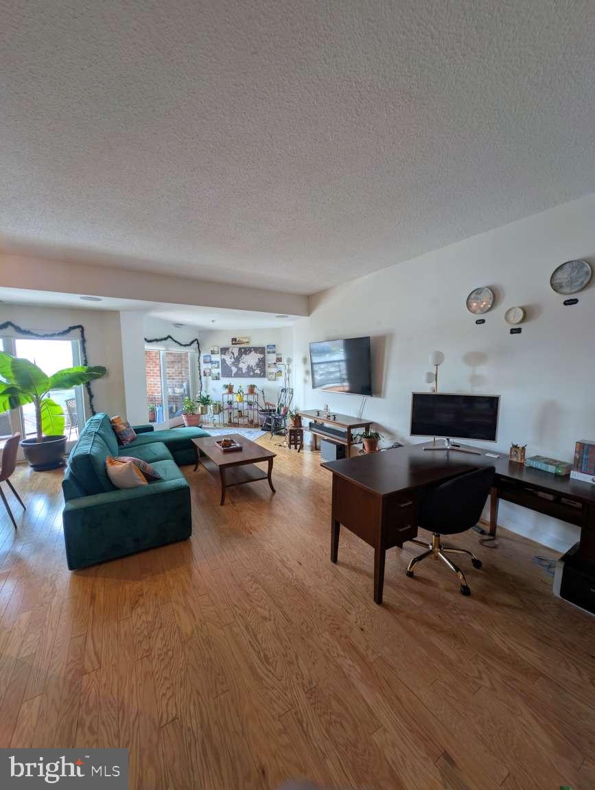 Welcome to Unit 1206 in the Anchorage Towers, a secure luxury high-rise located on the Waterfront Promenade in Canton! The building features breathtaking harbor views, two secured parking spots in the garage, direct access to the Promenade, and 24-hour staffing at the front desk. #1206 is a 2-bedroom, 2-bathroom unit with an open kitchen/living/dining layout and spectacular water views from a large balcony. The kitchen has lots of cabinet storage, under-cabinet lights, a large pantry, and a lovely kitchen island that adds a ton of counter space and makes cooking a delight. The living and dining area blend seamlessly together and are accentuated by two sliding Anderson doors leading to a large west-facing balcony which bathes the unit with great sunlight and provides a vantage point for spectacular sunsets. The unique shape of the Anchorage Tower provides natural angles with which to partition the room – the current setup features a dining area, living room, office space, and an indoor garden. A hallway from the entrance leads to the hallway bathroom and laundry closet, a guest bedroom overlooking Canton and Patterson Park, and the master bedroom with en-suite bathroom featuring a beautiful walk-in shower and double vanity. As an additional perk, the living room and master bedroom are wired with in-ceiling Bose speakers! The building additionally features a fitness room and community room available to all residents, and a storage space that conveys with the deed. There is a secured bike room in the garage as well. Located across the street from Safeway grocery store, and just steps away from wonderful coffeeshops, restaurants, bars, and shops. Get to I-95 in minutes, or use the city buses which stop along Boston Street, or the water taxi which has a stop in the Canton Waterfront Park. Schedule a showing and come see this beautiful oasis in the heart of Baltimore!