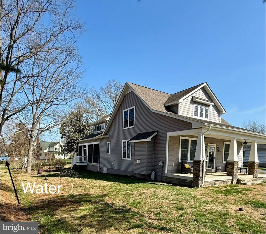 This beautifully maintained and custom designed, 7-year-young home sits proudly on a corner peninsula lot, offering water views from both the front and back. Welcome to a rare opportunity for coastal living in a sought-after Edgewater community, just blocks from multiple marinas and ideally positioned between Cadle Creek and the Rhode River. Step inside to an inviting open floor plan featuring gorgeous natural wood floors, recessed lighting, and a warm living room with gas fireplace. The stunning kitchen is complete with leathered granite countertops with a rock-face edge, a unique tile backsplash, and thoughtful finishes throughout. The main level offers 2 bedrooms and 2 full baths, including a primary en suite, creating an ideal layout for everyday living. 9-foot ceilings on both levels add volume and natural light. Upstairs, you’ll find a massive 40x20 bonus room perfect for entertaining, along with 2 additional bedrooms and a full bath, offering excellent flexibility for guests or extended living. Outdoor living truly shines—enjoy a full-length front porch that enhances curb appeal, and unwind on the expansive screened-in back porch, where you can sip your morning coffee overlooking the water or host gatherings with plenty of space for dining and relaxing. Additional highlights include a lovely 2 Car garage and a geothermal heat pump with desuperheater for enhanced energy efficiency. Ideally located in a desirable Edgewater setting, this home offers the perfect blend of comfort, style, and waterfront lifestyle—without compromise.