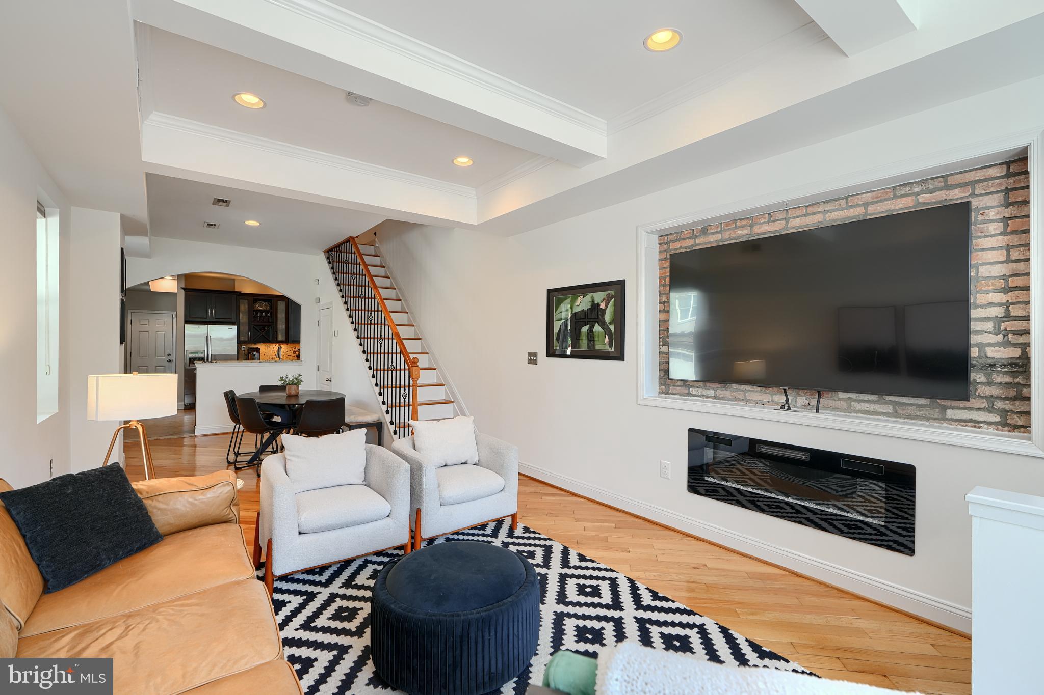 Introducing 3500 Fait Ave situated in the heart of CANTON! This 14 ft wide end-of-group residence boasts 4 bedrooms, 3. baths & 1-car parking. Enter the front door into the spacious living room you are greeted with gleaming diagonal hardwood floors, coffered ceilings w/ recessed lighting & exposed brick. Living & Dining rooms seamlessly blend and flow into the large kitchen w/ tiled floors, granite counters & top of the line appliances. half-Bath is just beyond the kitchen by the rear door that exits to your 1 -car parking pad. The upper level features 2 bedroom and 2 full baths. Primary en-suite bedroom w/ 10 ft ceiling, walk- closets & spa inspired bath w/ dual vanities , tiled shower & bidet. Secondary bedroom w/ French door access to the rear sitting deck. Lower level has 2 additional bedrooms, full updated bath w/ walk-in shower & laundry. Just a short walk to Patterson Park. Easy access to shopping at Canton Crossing & commuter routes, I95, 895. Schedule your tour today! **NEW ROOF**