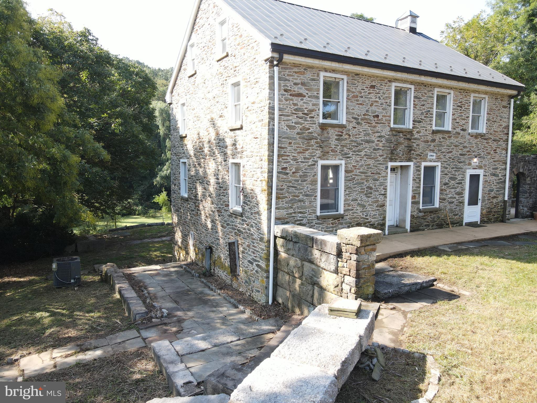 This property will be offered at Public Auction on Monday, November 4, 2024 @ 1pm. The listing price is the opening bid only and in no way reflects the final sale price. 10% down due at auction, 2% transfer tax to be paid by the purchaser, real estate taxes prorated. This 81-acre farm in Manor Township presents a picturesque setting with its charming limestone home, expansive tillable acreage, wooded areas, and a large pond. The limestone home features steel bridge construction, allowing future owners the flexibility to rearrange the interior layout. Inspired by Italian country homes, the interior showcases plaster walls, reminiscent of the owner's birthplace. The first floor features imported Italian marble flooring, a spacious kitchen with custom cabinetry, a formal dining room, and a living room with custom inlaid, two story, wood ceiling with a large iron chandelier. The study is equipped with built-in bookcases, and the three full bathrooms are finished with imported Italian marble floors and sills. The second floor can be accessed by a custom open steel and wood staircase and boasts 3 bedrooms with oak flooring. The lower level of the home consists of a large basement with high ceilings, cellar storage and garage. Additional amenities include a concrete patio, a modern two-story bank barn that has been rebuilt within the last 8 years, recreational spaces on the property, and convenient access to the Susquehanna River. This property enrolled in Clean & Green and Ag Preserve.