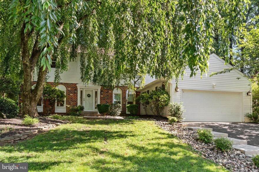 Welcome to 812 Green Ridge Circle.  This thoughtfully maintained and tastefully upgraded home sits in the coveted Woodlyn Crossing community and offers nearly 2,800 square feet of comfortable living. Filled with natural light, stylish finishes, and versatile spaces, it’s designed for both everyday enjoyment and memorable gatherings.  Enter through the bright, welcoming foyer, where a dramatic staircase makes a striking first impression. The updated kitchen shines with quartz counter tops, a custom tile back splash, newer stainless appliances, and a cheerful breakfast nook—perfect for morning coffee. The adjacent family room, with its wood-burning fireplace and dual sliding doors, opens to a private brick courtyard—an ideal retreat for relaxing or entertaining outdoors. A formal dining room and spacious living room provide plenty of room for hosting, while a powder room and first-floor laundry with laundry chute add convenience to daily living.  Upstairs, the primary suite offers a peaceful retreat with a large sitting/dressing area, double-door entry, walk-in closet, and an updated en suite bath featuring a new shower and granite-topped vanity. Three additional bedrooms are generously sized with ample storage and share a beautifully renovated hall bath.  Notable updates include newer windows, siding, front door, water heater, and more—ensuring peace of mind for the next owner. The backyard feels like a private park, perfect for gardening, entertaining, or simply unwinding.   Woodlyn Crossing is known for its scenic setting, ponds, and access to community amenities including a pool, tennis, and pickleball courts. This home is a wonderful opportunity to combine comfort, convenience, and community in one desirable package.