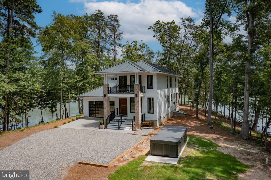 Designer touches accent this exceptional waterfront home newly built on Carter’s Creek. The two level modern style highlights the 180° water views and offers a comfortable but spacious floor plan. Custom built from top to bottom, inside and out, this home features top of the line appliances and fixtures, solid hardwood floors, Brazilian wood custom doors, extensive tile work, marble counters Weathershield doors and windows, 10’ + ceilings and multiple balconies, porches, and outdoor living spaces. Situated on 2+ acres with perfect elevation and wraparound views, this modern yet coastal home was carefully designed for its surroundings. New dock to 4' MLW (to be built). Located within sight of the Tides Inn and an easy boat ride to many waterfront restaurants and towns!