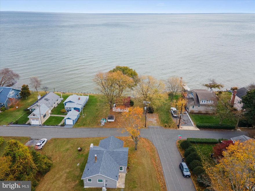 Waterfront OPPORTUNITY -  on the Chesapeake Bay. The right buyer will see it. The right strategy gets them there.This true waterfront cottage delivers stunning panoramic views and sits in a desirable community with access to a private boat ramp and neighborhood beach for a small annual fee. The home features 2 bedrooms, 1 bath, an open layout, and updates that include a newer roof (within the last 5 years), newer windows, some updated lighting, bamboo flooring, electric heat, and modern appliances. The septic was pumped within the past six months, and the home has public water. If you’re looking for minimal living as-is or a project with major upside, this property offers both. The current owner has already spoken with the county; you may be able to extend the existing footprint approximately 10–12 feet and add a second story (buyers should verify directly with the county). A pier permit or an L-shaped pier option of about 50 feet is also possible. Whether you want a simple waterfront retreat or the chance to build out a larger Bayfront home, this is a rare opportunity to make something special on the water.

NOTICE: Use caution when approaching the stairs leading toward the bulkhead/water. Some boards are damaged. Walk at your own risk.
