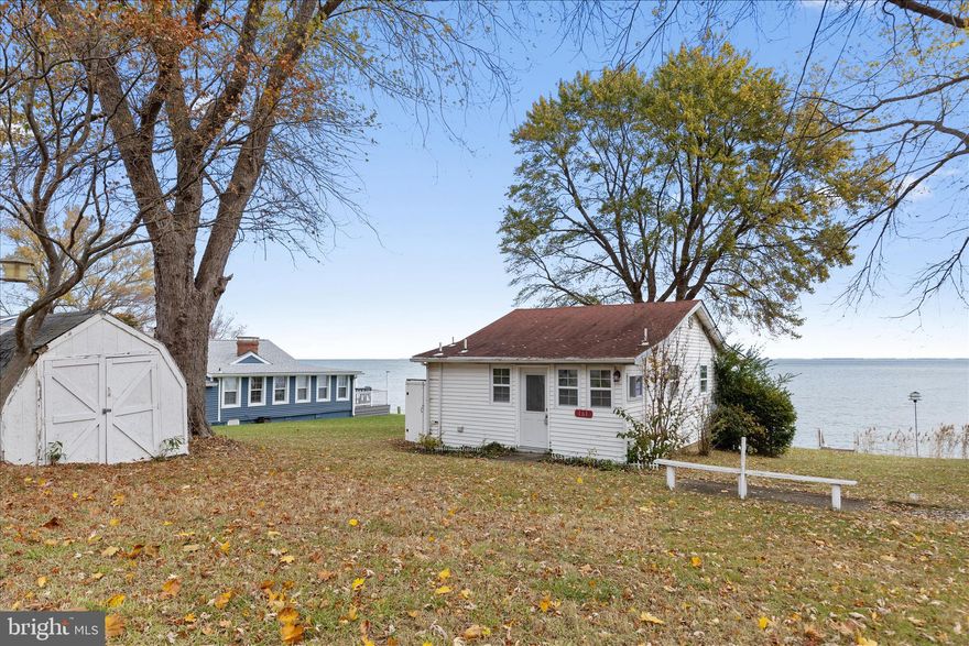 Opportunity and potential on the Chesapeake Bay. This true waterfront cottage delivers stunning panoramic views and sits in a desirable community with access to a private boat ramp and neighborhood beach for a small annual fee. The home features 2 bedrooms, 1 bath, an open layout, and updates that include a newer roof (within the last 5 years), newer windows, some updated lighting, bamboo flooring, electric heat, and modern appliances. The septic was pumped within the past six months, and the home has public water. If you’re looking for minimal living as-is or a project with major upside, this property offers both. The current owner has already spoken with the county; you may be able to extend the existing footprint approximately 10–12 feet and add a second story (buyers should verify directly with the county). A pier permit or an L-shaped pier option of about 50 feet is also possible. Whether you want a simple waterfront retreat or the chance to build out a larger Bayfront home, this is a rare opportunity to make something special on the water.

NOTICE: Use caution when approaching the stairs leading toward the bulkhead/water. Some boards are damaged. Walk at your own risk.