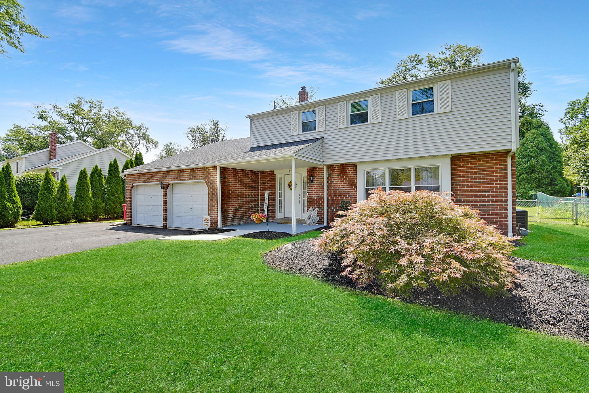 Welcome to 22 Sandown Road, Norristown – a beautifully remodeled single-family home in sought-after Lower Providence Township and the award-winning Methacton School District! From the moment you arrive, this home impresses with its thoughtful updates and spacious layout. The showpiece of the home is the stunning new kitchen, featuring white cabinetry with elegant gold accents, Taj Mahal Quartzite countertops, custom tile backsplash, and high-end stainless steel appliances—including a gas slide-in range. The oversized island offers seating for at least four, ideal for casual meals or entertaining, and the separate dining area with sliders (featuring built-in shades) opens to the expansive covered rear patio. The living room is bright and inviting, with neutral carpeting, crown molding, recessed lighting, and a large triple front window that floods the space with natural light. A separate family room features a gorgeous stone accent wall with a brand-new natural gas fireplace insert, ceiling fan, and another set of sliders leading to a tiled three-season sunroom—perfect for relaxing. The main floor also includes a convenient powder room, laundry room with utility sink, and interior access to the oversized two-car garage. Upstairs, the primary bedroom features a ceiling fan and private en-suite bath with tile flooring, tub, and tile surround. Three additional generously sized bedrooms (one with a ceiling fan) share a hall bath with a double vanity, tile floors, and a tiled tub surround. You’ll also find pull-down attic access and a massive bonus room (awaiting your flooring of choice) that can easily serve as a fifth bedroom, playroom, or home office. The full basement offers nearly 900 square feet of unfinished space, ready for your creative vision. Outdoor living is just as impressive, with a charming covered front porch and a sprawling covered rear patio equipped with recessed lighting, skylights, and a ceiling fan—perfect for entertaining or quiet evenings. The large, level backyard is fully fenced and includes a sizable storage shed. Additional recent upgrades include a brand-new dual-zone HVAC system with all new ductwork, a new asphalt driveway with parking for seven or more cars, new sewer lateral from house to street, water softener system and a radon remediation system. The entire home is painted in neutral colors and truly needs nothing except its next owners! All of this in a prime location near Trooper and Egypt Roads, with easy access to Route 422, Valley Forge National Park, and King of Prussia Mall. This is the turnkey home you’ve been waiting for—schedule your private tour today!