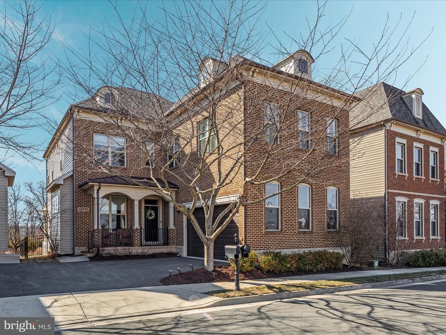 Breathtaking ONE Loudoun showstopper! Award winning craftsman style Roxbury model by Camberley Homes. Spectacular premium lot backing to conservation area boasting privacy and serenity in the most peaceful corner of prestigious ONE Loudoun! Timeless brick front elevation with side load two car garage and an incredible front porch to enjoy your morning coffee. As you walk through the threshold of this masterpiece of a home, the open floorplan and stunning foyer will invite you into the heart of the home. Gorgeous trimwork everywhere! Magnificent hardwood floors throughout! Plantation shutters throughout. Grand curved staircase adorned with custom trimwork is the perfect setting for those prom night photos! You will not be able to enter this home without commenting on its beauty and class. Impressive formal dining room to enjoy those large family gatherings. Luxurious guest bathroom is conveniently tucked away. Spacious receiving room (currently being used as a music room) leads to a stately home office with custom built-ins. The splendid mudroom with magnificent wainscotting will become your family's landing area. As you continue into the heart of the home you will be impressed by the spacious gourmet kitchen overlooking the grand family room with impressive, coffered ceiling, gas fireplace, and wall of windows allowing natural light to fill the home! Kitchen is strikingly luxurious with grand butler's pantry, high end stainless steel appliances, gorgeous white cabinetry with soft close and dovetail construction, highly upgraded quartz countertops, pendant lights over the counter height breakfast bar, separate cooktop with convenient pot filler, and large pantry!!! Kitchen leads out to a covered pergola deck with stairs down to fully fenced backyard and patio with "smart" fans and lights controlled from a phone app! The floorplan upstairs is spectacular; featuring a massive loft with stunning bookcase and desk built-ins; perfect for 2nd family room, a quiet study for the teens, or epic slumber parties!!! Primary suite with striking trey ceiling, large, double walk in closets, beautiful, separate raised "his and hers" counters, walk in shower and separate tub. Luxurious en-suite bedroom with private bathroom and walk in closet. Bedrooms 3 & 4 share a beautifully designed "Jack and Jill" bathroom with separate shower area. The basement is fully finished with a massive recreation room with elegant built-in wet bar with cabinets, upgraded countertop, refrigerator and sink! Fabulous media room with screen and equipment to convey. Full bathroom in basement. Hobby room that could double as a guest bedroom. Storage room. Enjoy the luxury and convenience of front and rear lawn maintenance, snow removal and seasonal landscaping managed by the ONE Loudoun community. Close to everything; Top Golf, iFly, Trader Joe's, Alamo movies, and endless shopping and dining. ONE Loudoun is a commuter's dream with close proximity to Route 7, Route 28, the Dulles Toll Road, Dulles International Airport, and the Ashburn Metro Station. Perfect 10. This home has it all.
