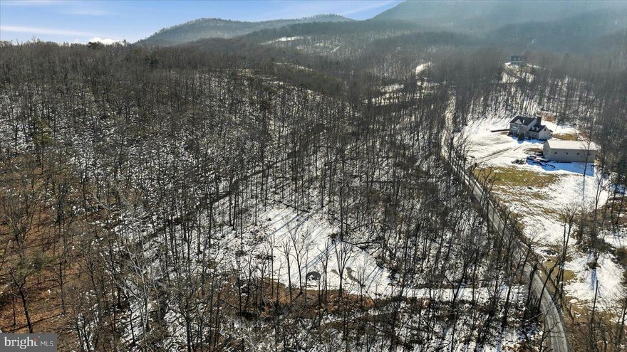 5 beautiful acres with views of Signal Knob. There is a gated driveway that leads to a cleared, level area, ready for your vision.  A Septic Certification Letter for a 3-bedroom home (now expired) is available in the documents section, and the approved perk site is conveniently located next to the cleared area. A nice creek outlines part of the property and a natural spring is located on southern border. 

The west side of Stoney Mountain Drive Estates backs directly to the George Washington National Forest, offering privacy and direct access to nature. 

Conveniently  located in between Downtown Strasburg, Knob Creek Playground, the Strasburg Riverwalk, Elizabeth Furnace Camp Grounds, and Buzzard Rock—all within a 10-minute drive. Close proximity to the Shenandoah River and Skyline Drive gives easy access to some of Virginia's most beautiful sceneries. Less than 15 minutes to I81 and Rt. 66.