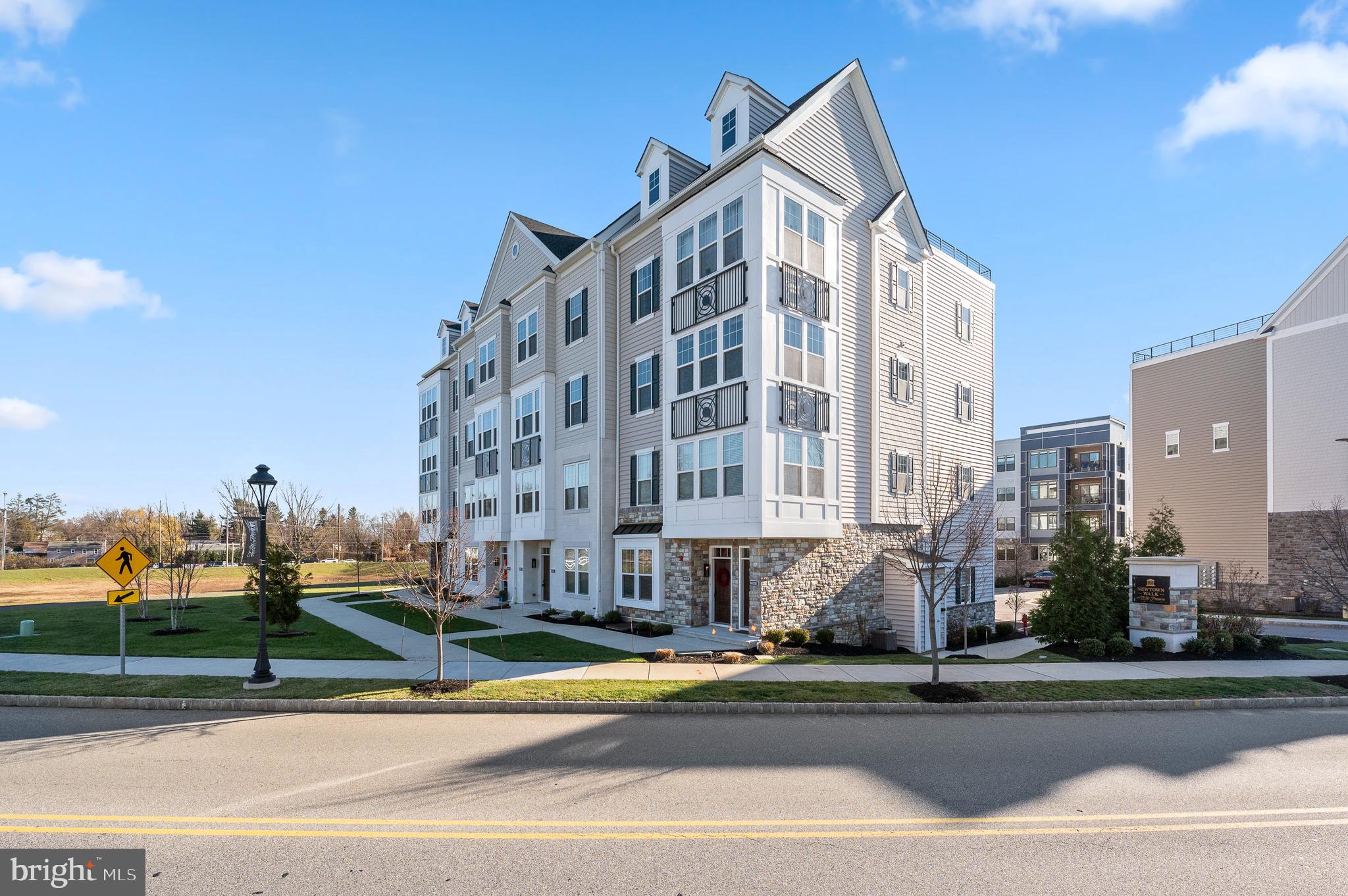 Welcome to this stunning, upscale Townhome in the very coveted Newtown Walk at Ellis Preserve. This urban lifestyle townhome mixed with turn-key living is located in a convenient, walkable suburban setting. This luxurious townhome built in 2020 has tasteful upgrades throughout with two covered balconies and an incredible Rooftop Deck with sweeping views. Enjoy the open floor plan with attached garage and private driveway. Recently installed custom shelving at the entry makes for a convenient place to be organized as you enter and leave the home. The main living area boasts a generous size great room, upgraded with custom Shiplap and floor to ceiling paneling. The large windows offer plenty of natural light and pretty views. This level is enhanced with 9’ ceilings, hardwood floors, crown molding and recessed lighting. The stunning gourmet kitchen is the heart of the home with brand new quartz countertops, new cabinet hardware, large island with seating, upgraded light fixtures and stainless steel appliances. The breakfast nook and dining area conveniently access the covered balcony, which is perfect for relaxing or entertaining. The half bath completes this level with a new modern vanity and recently installed designer wall covering. The next level offers a beautiful Primary Suite, two additional bedrooms, hall bath and convenient laundry area. Enter the Primary Suite through double doors to a generous size bedroom with 9’ ceilings, two large walk-in closets, and glass doors leading to a private covered balcony. The Primary bath has two “extended height” vanities, an oversized shower, 12x12 square tiled flooring and new window blinds. The second bedroom is elevated with custom shiplap and new blinds in both additional bedrooms. Finally, the expansive rooftop deck is spectacular. It is the perfect place to entertain, relax and enjoy amazing sunset views and mature greenery. This home feels brand new and is a tremendous opportunity to be in a walkable area close to shopping, dining, trails, public and private schools, private golf clubs and only 20 mins to the Philadelphia International Airport and approximately 10 minutes to the Paoli train station with service to Philadelphia and NY.