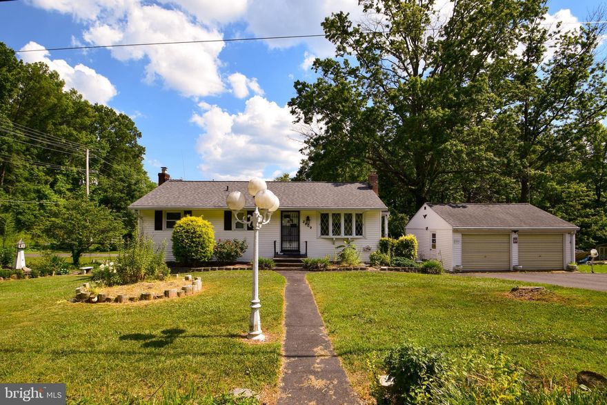 Don't miss this exceptionally charming Rancher, newly updated & situated on an awesome 2/3 ac corner lot with stream, lots of extras & second driveway w/ electric for RV, boat or additional parking! Freshly painted inside & out, new fixtures throughout, Corian counters, brand new laminate flooring in Kitchen & finished walk-out basement, 2 full, updated baths & awesome 4-season room flanked by 2 decks overlooking your little piece of heaven, complete with ornamental pond w/ new pump & waterfall! Open layout in the completely remodeled basement easily accommodates your ideas/needs with 2 entrances, full bath, flue & brick hearth for wood stove & room to add possible 3rd bedroom or separate living quarters. Slider opens to fantastic covered patio & fenced play area.  Oversize 2-car garage & tons of additional parking, plus workshop with attached storage shed great for your hobbies, toys or equipment. Newer roof, HVAC, hot water heater, updated wiring & more lets you move right in worry-free! Feels out of the way, yet a stone's throw to major commuter routes & local attractions. More photos coming soon. A must see!!