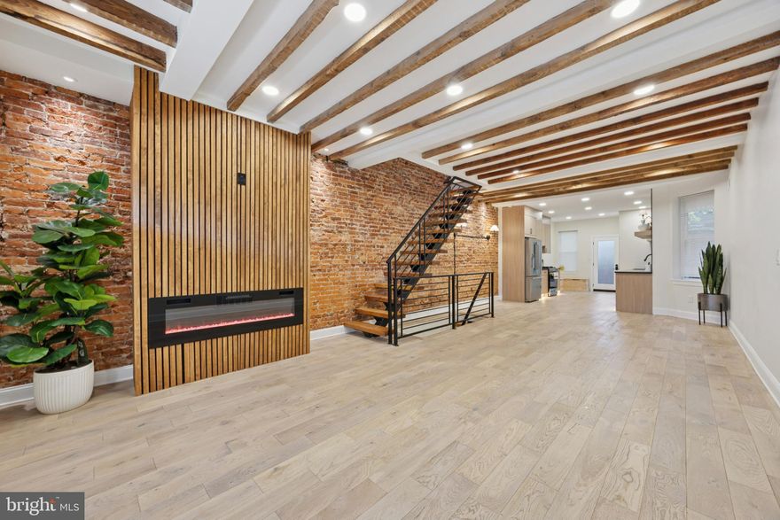 Welcome to a One-of-a-Kind, Fully Renovated 3 Bedroom, 3.5 Bathroom Home in Philadelphia's University City - Cedar Park  Area.

Discover the perfect blend of modern luxury and rustic charm in this beautifully renovated home in the heart of Cedar Park. Every detail has been thoughtfully designed, featuring exposed brick walls, floating stairs, and exposed joist ceilings, creating a unique farmhouse feel with contemporary elegance.

Step inside to a bright, open floor plan with high ceilings and stunning hardwood floors throughout. The spacious living room flows effortlessly into a chef-inspired kitchen with quartz countertops, a stylish backsplash, modern flat-panel sand cabinetry, and stainless-steel appliances that will inspire any cook. A convenient half-bath completes the main level.

Upstairs, the master suite serves as a true retreat, offering his-and-hers closets, a private full bathroom with a luxury vanity, granite tile, and a powerful walk-in shower. The master fireplace mirrors the living room fireplace below, providing a striking vertical design element that adds warmth and sophistication. Two additional bedrooms feature exposed brick accents, recessed lighting, hardwood floors, and ample closet space. The hallway bathroom has been updated with modern finishes and high-end fixtures.

The fully finished basement provides an additional living space, which includes a full bathroom & dedicated laundry area. The open layout features is a spacious office / flex room, ideal for working from home, gaming, yoga studio, Peloton space, media room, or recreation area.

This home offers peace of mind with all-new major systems, including a brand-new roof, heating system, central air, and hot water heater, ensuring low-maintenance living for years to come.

Schedule your show and witness this exceptional home in person. Located just steps from the vibrant Baltimore Avenue corridor, residents enjoy local favorites such as Dock Street Brewery, Booker’s Restaurant, Vix Emporium, Hibiscus Café, Loco Pez, Cedar Park Cafe, and Mariposa Food Co-op. With easy access to University City, Penn, Drexel, CHOP, the Schuylkill River Trail, Cedar Park, Clark Park, and Center City, this home combines convenience with style.